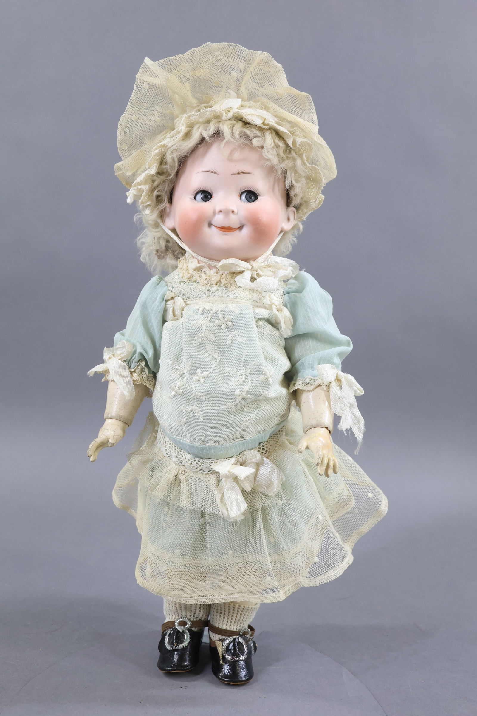 BISQUE GOOGLY EYE DOLLS.: 12 1/2" HERTEL & SCHWAB 173 - 3 1/2 Googly doll with lever flirty blue eyes. Closed watermelon smile, flaxen fur wig. Fully jointed papier mache toddler body. Dressed in vintage pale blue drop waist d