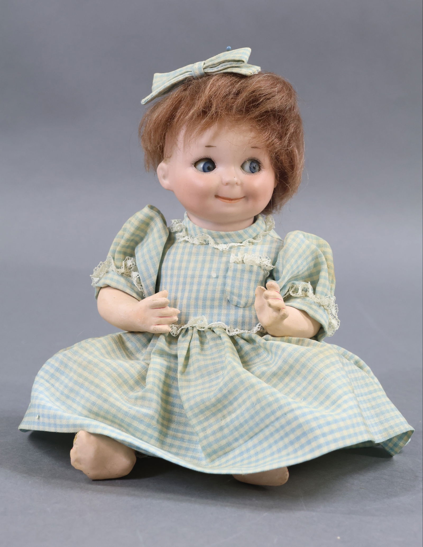 BISQUE GOOGLY EYE DOLLS.: 8 1/2" G.B. 253 GERMANY A.6/0.M. Googly doll. Blue side glance sleep eyes, watermelon smile, brown mohair wig. 5 Pc. papier mache bent limb baby body. Dressed in vintage cotton gingham dress, bow. Cot