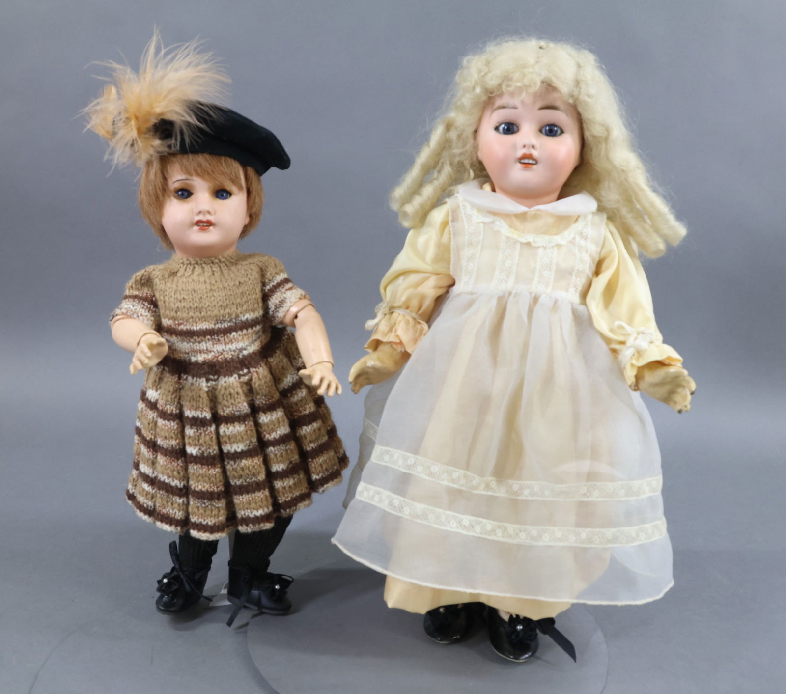 FRENCH BISQUE DOLLS.: Pair of dolls. Both dolls have blue eyes, open mouths, papier mache bodies, replaced clothing. Doll 1) 11" 71 UNIS FRANCE 149 301 with sleep eyes, brown HH wig, fully jointed body. Dressed in variegat