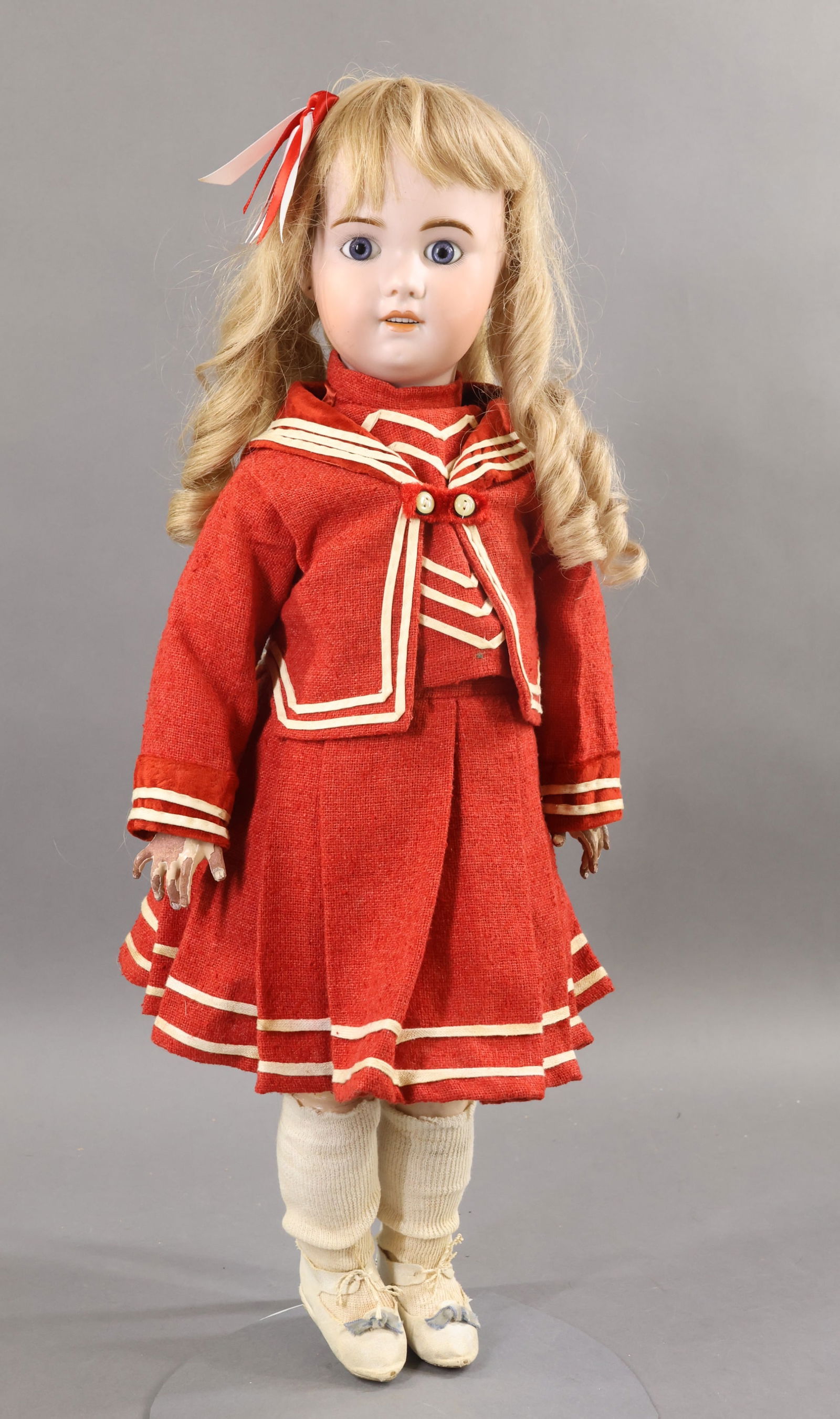 FRENCH BISQUE DOLLS.: 24" S.F.B.J. 230 PARIS 11 doll. Blue paperweight eyes, open mouth, pierced ears, long curly blonde French HH wig. Papier mache jointed body. Dressed in vintage 3 pc. red wool sailor outfit with white