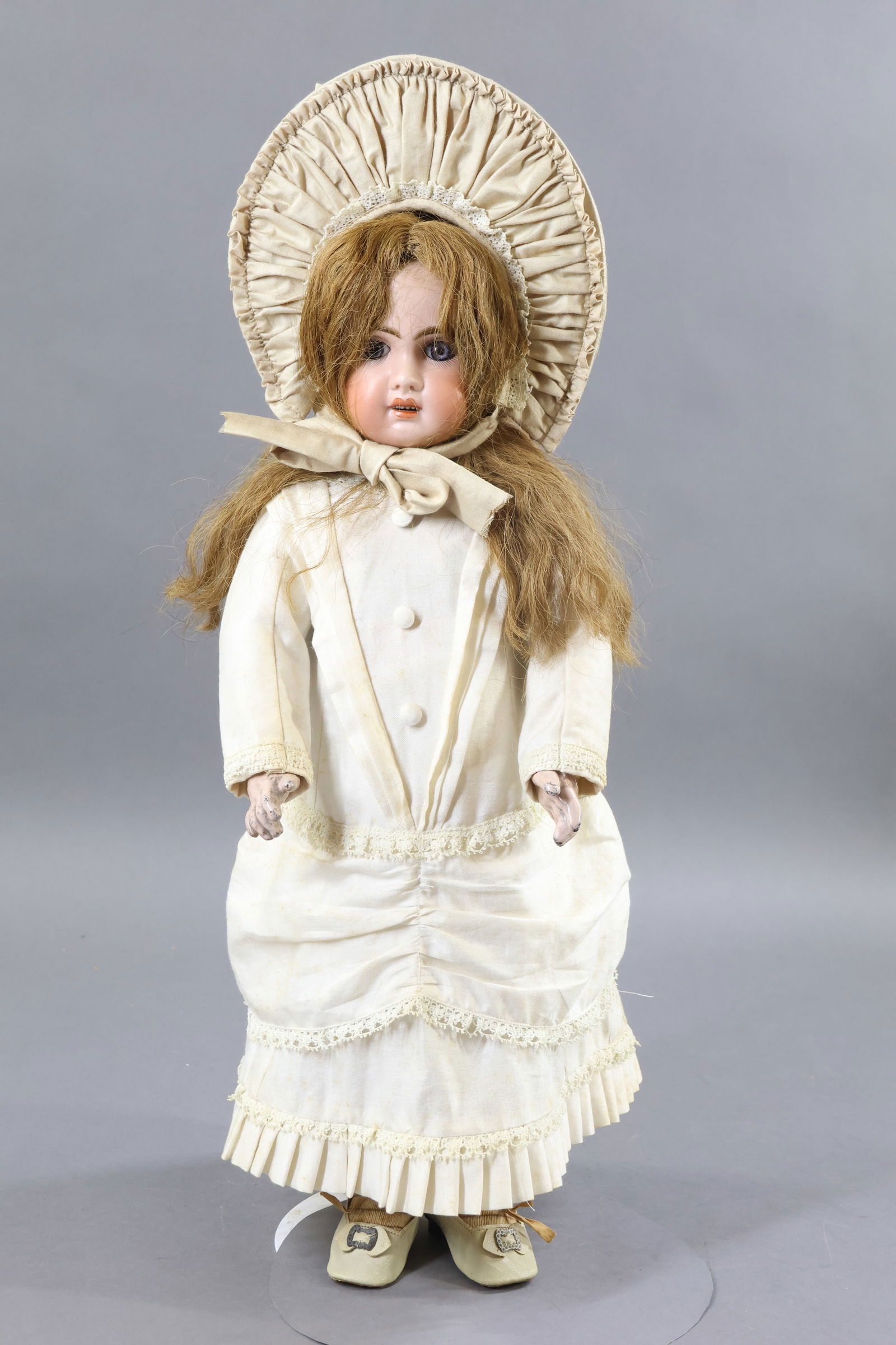 ANTIQUE FRENCH BISQUE HEAD DOLL.: 19" 1907 8 Doll with blue paperweight eyes, open mouth, pierced ears, long brown HH wig. Papier mache jointed body marked (blue stamp) BEBE JUMEAU DIPLOME d' HONNEUR. Separate hands. Dressed in vintag