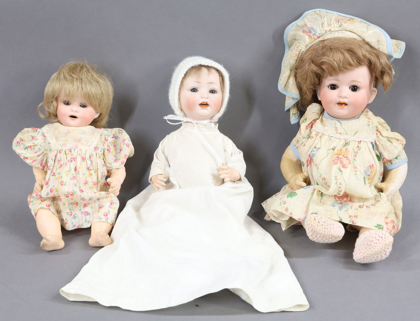 GERMAN BISQUE BABY DOLLS.: LOT of (3) character dolls. These dolls all have sleep eyes, open mouths, 5 pc. papier mache bent limb baby bodies. They are dressed in vintage/antique clothing. Doll 1) 9" HEUBACH KOPPLESDORF 300-13/