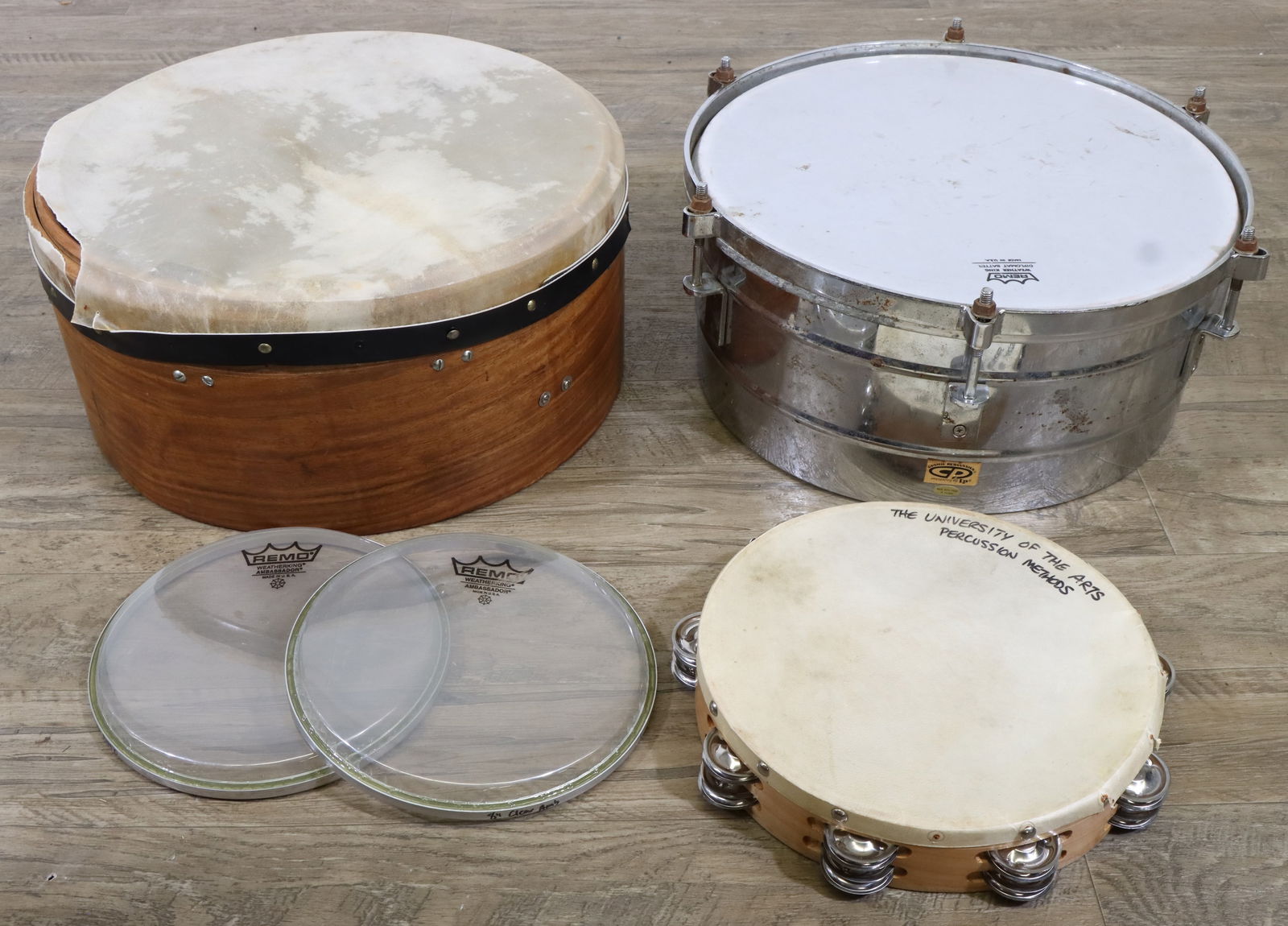 Miscellaneous Drums & Drum Parts: 15x6 tom tom with no mounting hardware; 16" frame drum; 10" tambourine; two 8" drum heads. All drums are in heavily used condition, except the 8" drum heads, which are in good condition.