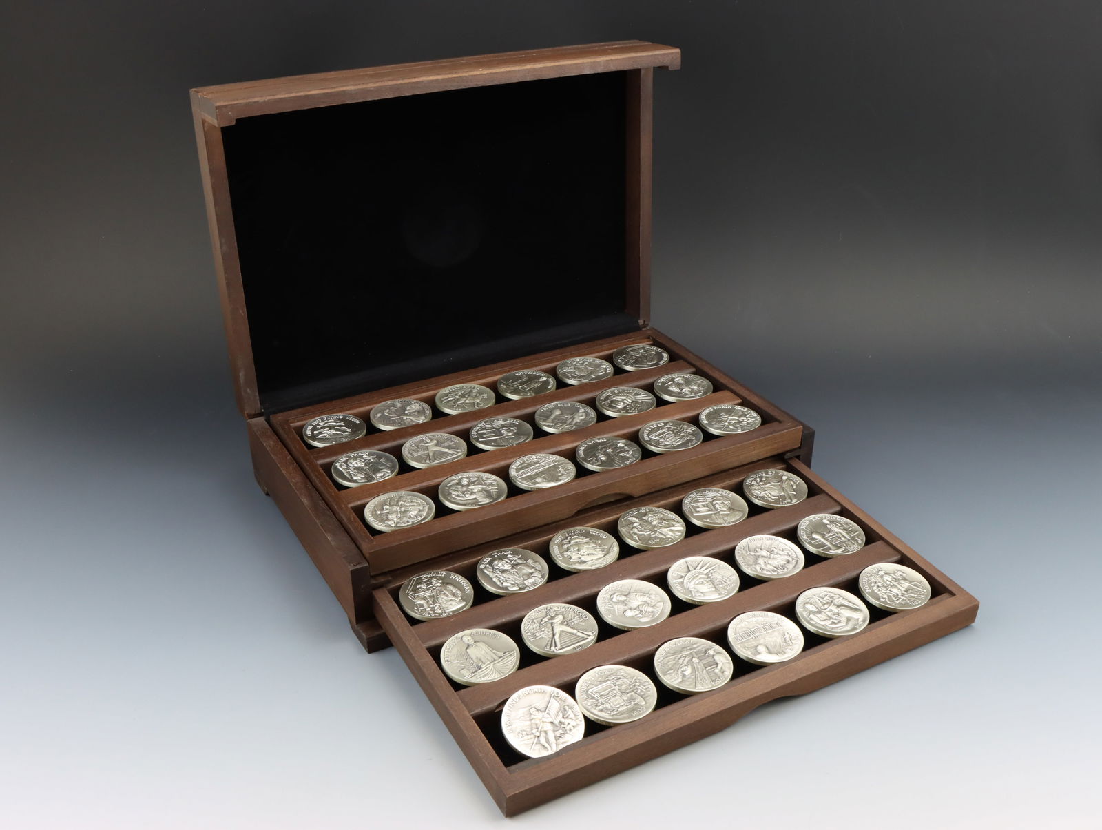 The Heritage of the Golden West Sterling Silver Medals: Longines Symphonette, "Heritage of the Golden West", (36) sterling silver medals, 1972, in wooden collector case, each medallion approx. 40 mm and 1.09 ozt, approx. 39.24 ozt overall