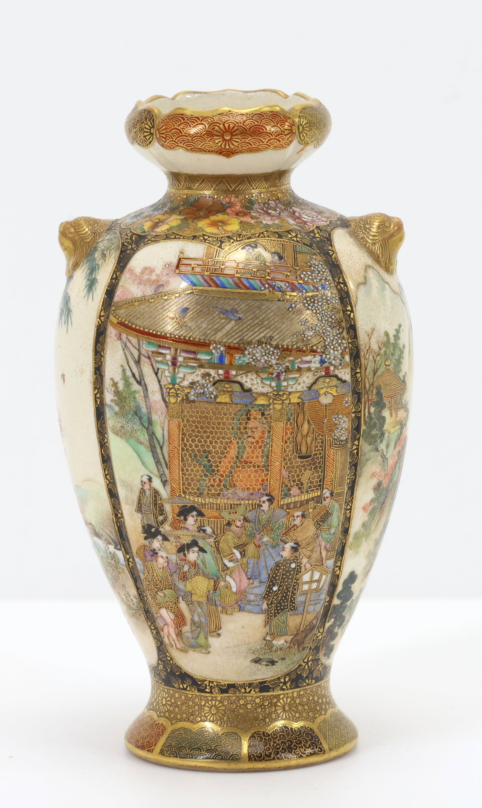 Japanese Satsuma Pottery Vase: Meiji - Taisho era Satsuma vase decorated with panels depicting Fugen in female form presenting a lotus to Buddha while various Raken look on, court attendants gathering in front of a Buddhist temple 