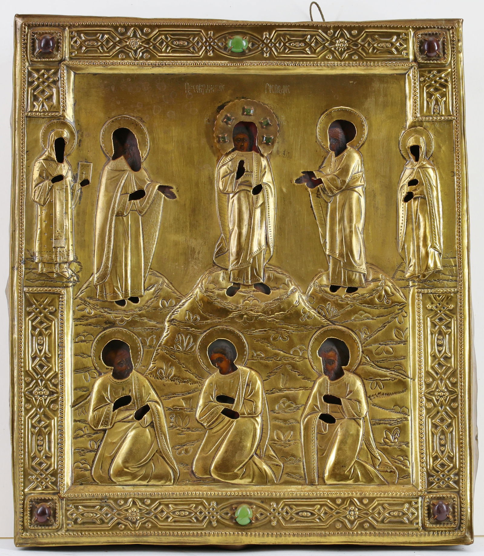 Russian Icon: Imperial Russian icon with a gilt oklad over tempera on gessoed panel, depicting Jesus surrounded by saints, the oklad with an applied halo inset with green gemstones, possibly emeralds or tourmaline,
