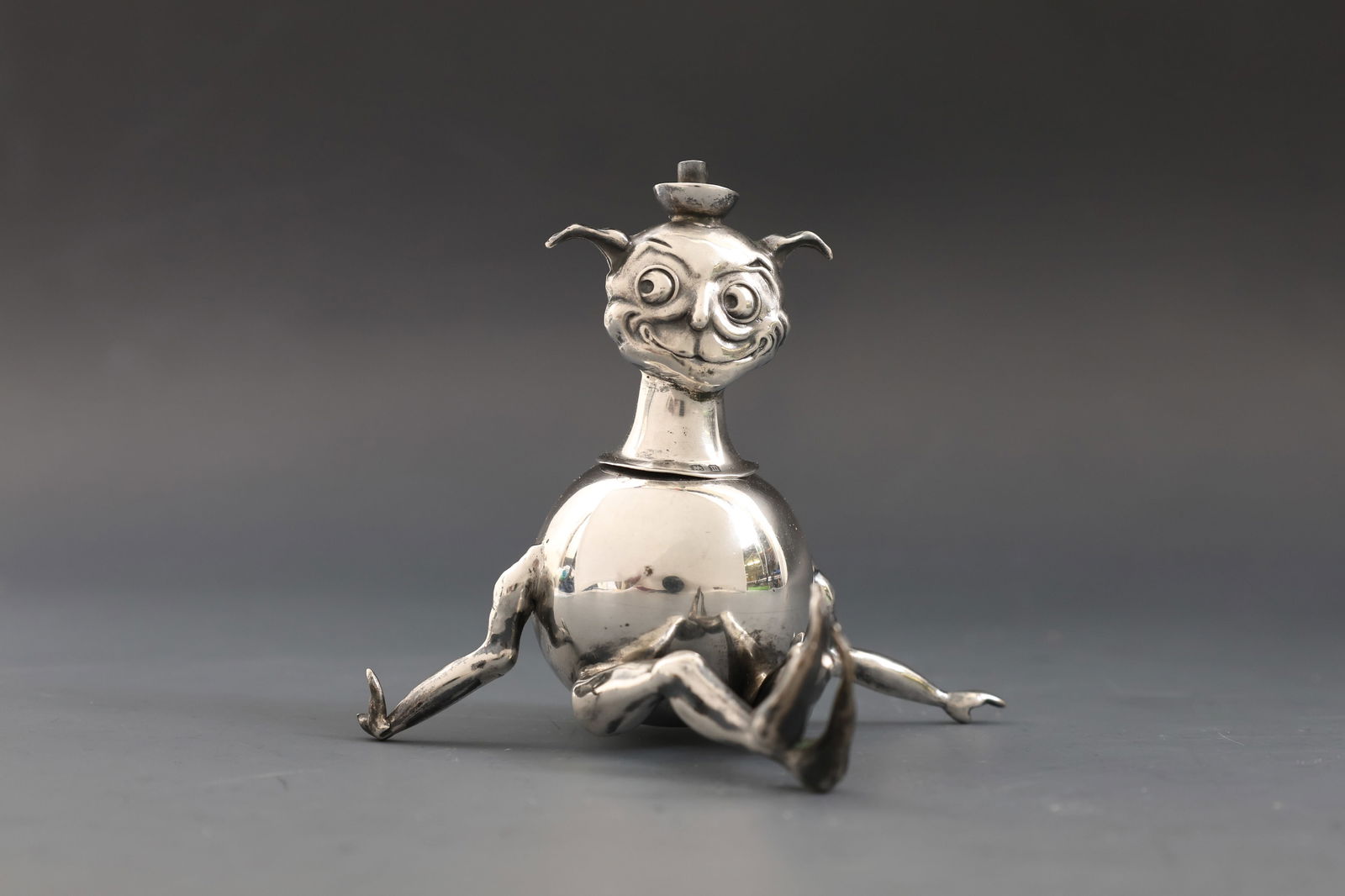 Edwardian British Sterling Silver Novelty Table Lighter: British sterling silver table lighter in the form of a seated imp, with removable head. Birmingham, 1911, by Philip Hanson Abbot. 3”h x 3.75”w x 2.75”d. 1.76 ozt