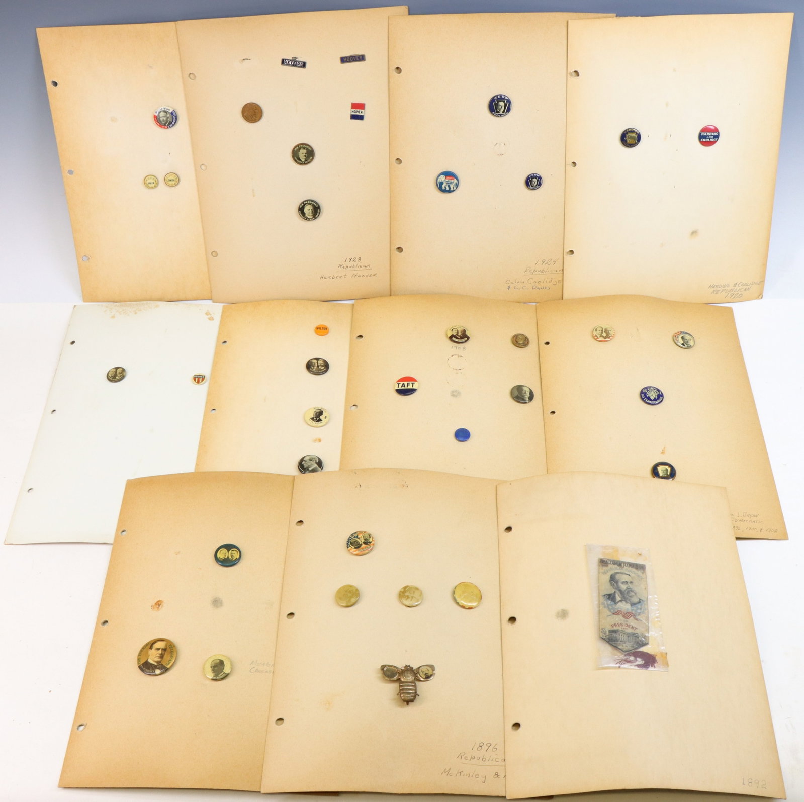 United States Political Pins/Ribbons-1890's thru 1928 Presidential Campaigns: Collection of United States political pins from the Presidential campaigns from 1892 thru 1928. Collection includes; 1.) A Benjamin Harrison Stevensgraph ribbon measuring 3.25" x 1.5". Ribbon exhibits