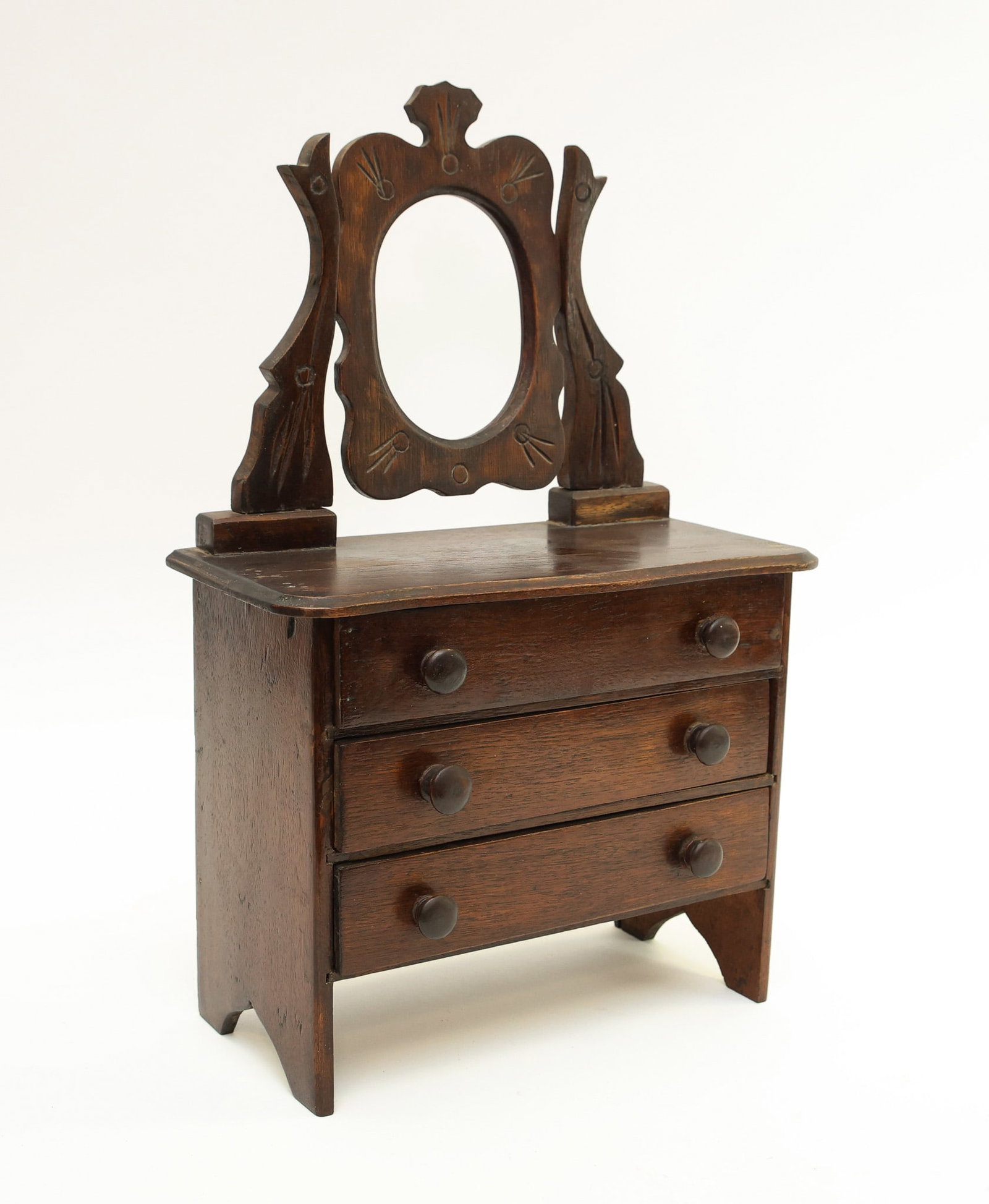 Doll Scale Furniture Dresser: Oak with an etched cheval mirror, chamfered edge serpentine top, three drawers on boot jack feet. 17"h x 11"w x 5.5"d