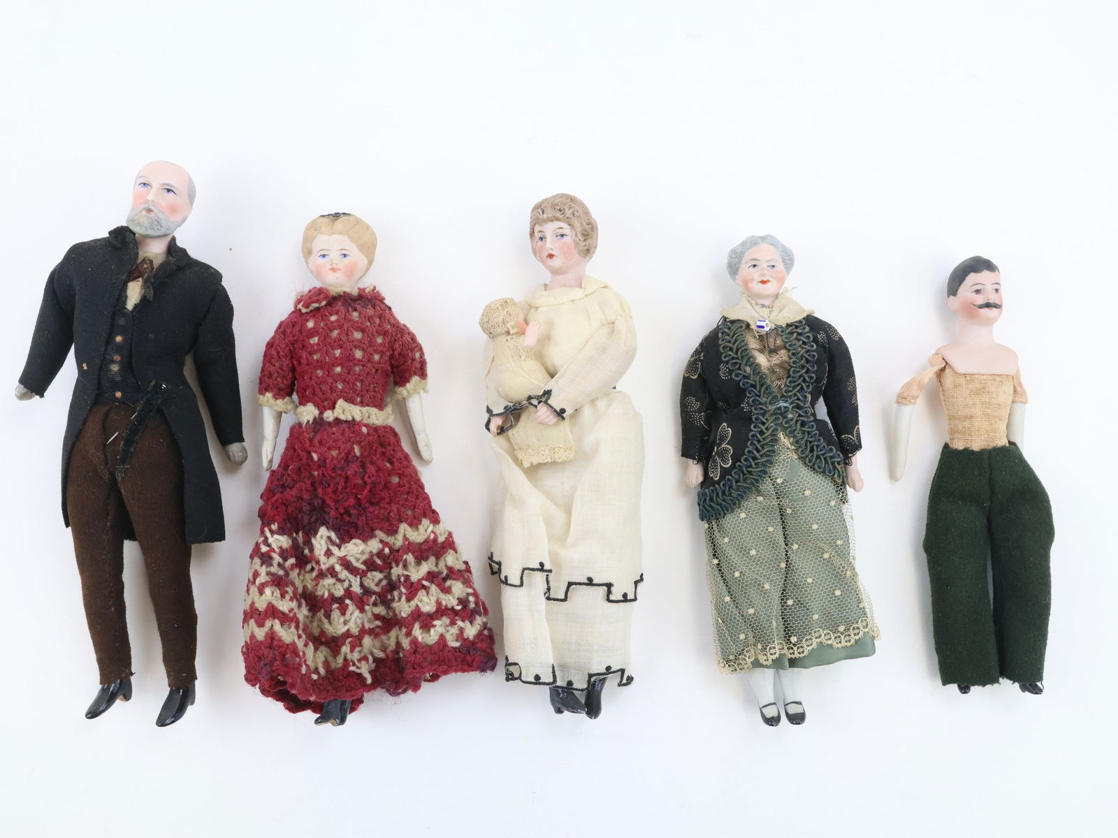 German Bisque Head Dollhouse Dolls: German character/dollhouse dolls (4) including a formally dressed man and woman, a mother holding a baby, a young lady wearing a crochet dress and a young man that is not fully dressed. All have bisqu