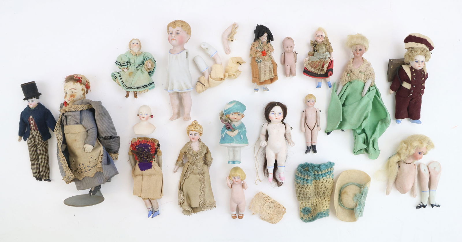 Antique Miniature Dolls: Collection of antique miniature dolls, including China dolls, German all bisque dollhouse doll and a nodder. Some have glass eyes and most are clothed. Condition: not all dolls are completed and/or st