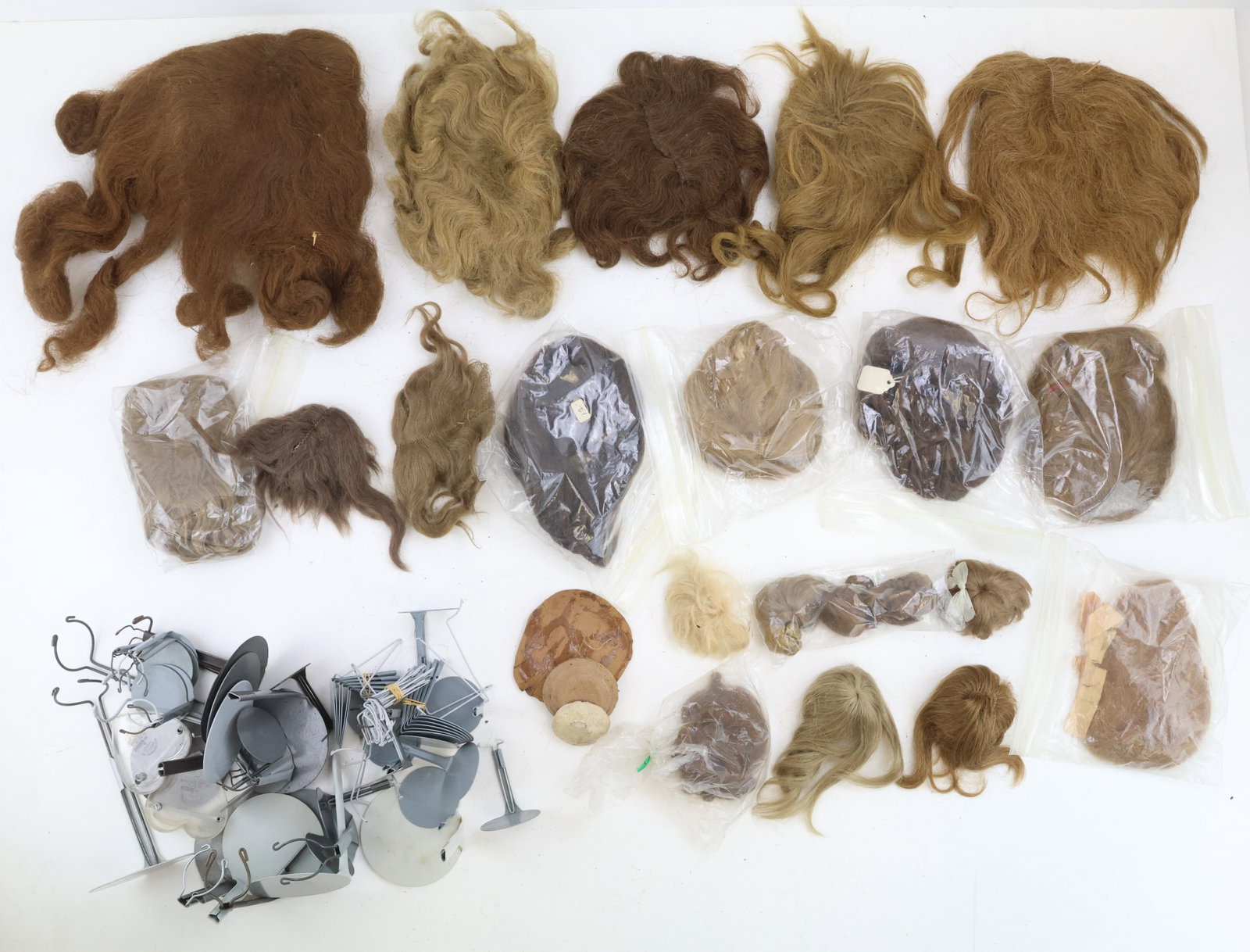 Doll Supplies: Antique doll wigs of various sizes and colors, made from human hair and mohair. Group of stands for 3" to 8" dolls