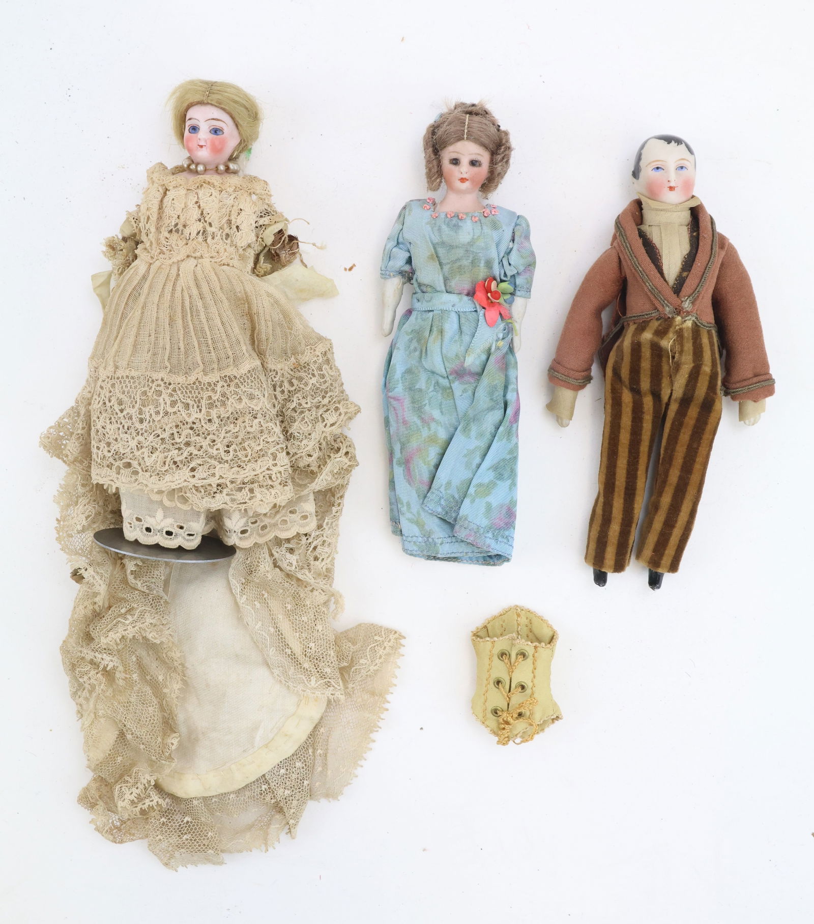 German Bisque Head Dolls (3): German Bisque Head Dolls (3) includes Simon & Halbig, male dollhouse doll in brown striped trousers and brown waist jacket, woman wearing blue dress with red flower accent and a woman wearing a period