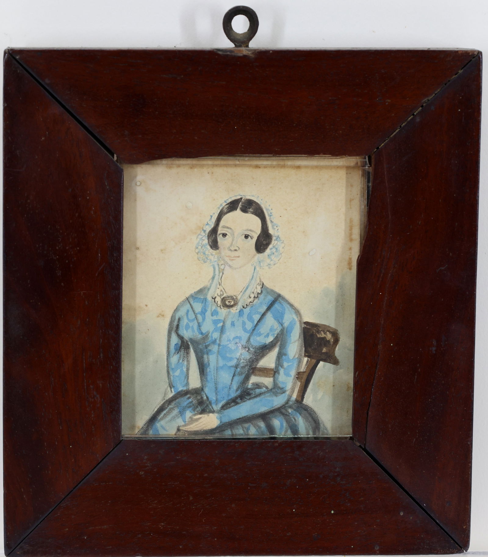 Watercolor Folk Art Drawing: Watercolor and graphite drawing of a seated young woman. Dark hair, center-parted with white head covering, blue dress with lace collar and oval broach. 6.25"h x 5.75" framed
