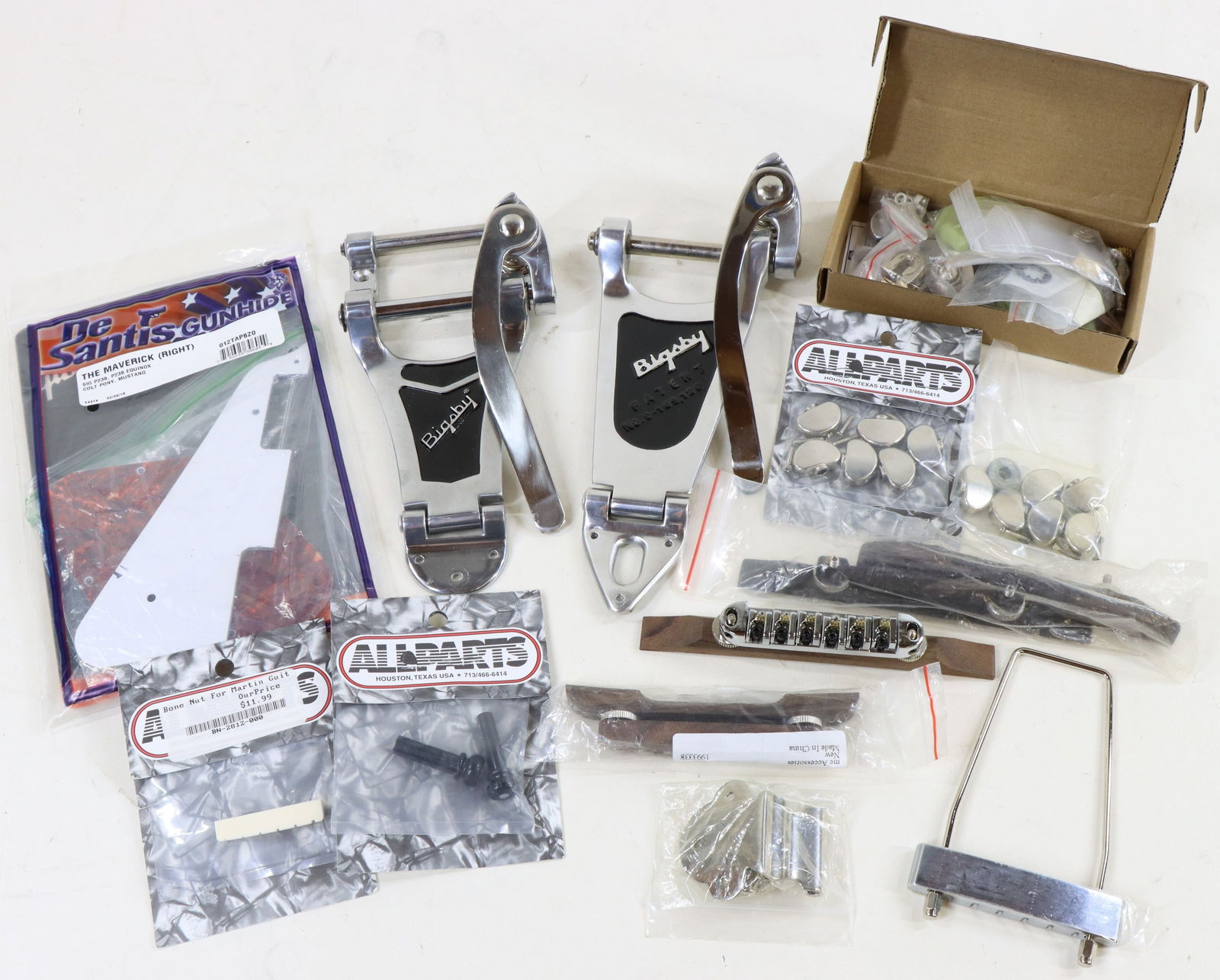 Electric and acoustic Guitar Parts: Bigsby tailpieces, adjustible bridges for acoustic and electric. Bone top nut for Martin Guitar. Gibson pick guards, tuning machine knobs, adjustible floating tailpiece, bridge pins and much more.