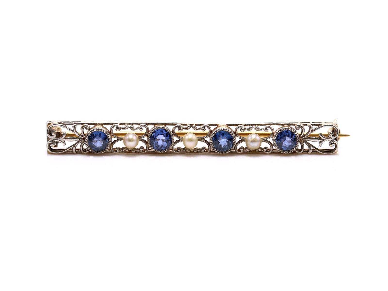 14k WG/YG Sapphire Pearl Pin: 14k yellow and white gold filigree bar brooch set with four round sapphires approx. .5carats total and three seed pearls, 1.75", 2.0dwt.