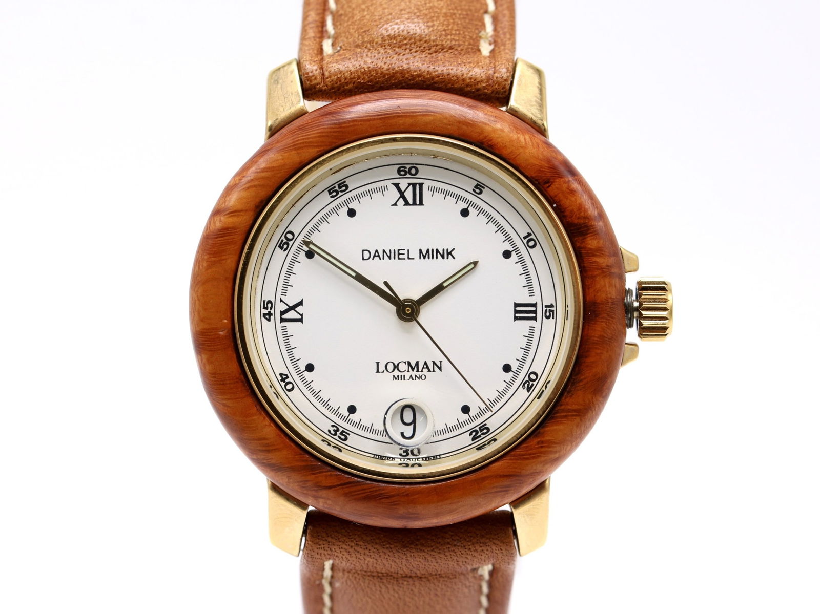 Daniel Mink by Locman, Automatic “Isola d’Elba" Wristwatch: Wood and gold tone case with automatic movement, Ref. 01671 signed Daniel Mink and Locman Milano, white dial with Roman numerals and date aperture at 6. Sapphire crystal, screw-down caseback marked Is