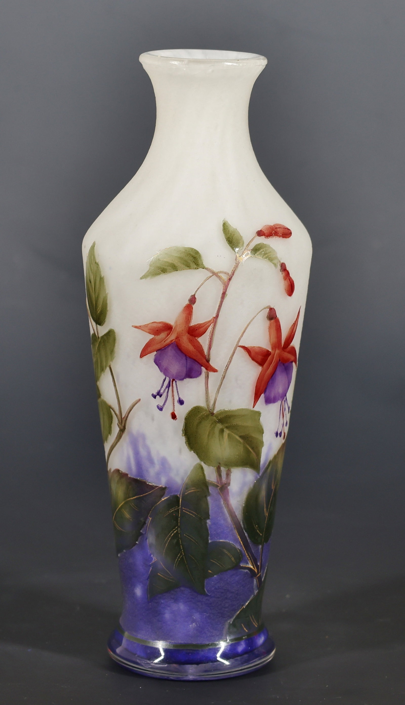 Daum Enameled Cameo Glass "Fuchsia" Vase: French Art Nouveau cameo glass vase, acid etched and enameled with gilt accents, decorated with fuchsia flowers on a cobalt blue and frosted ground. Marked Daum Nancy with the Cross of Lorraine to the