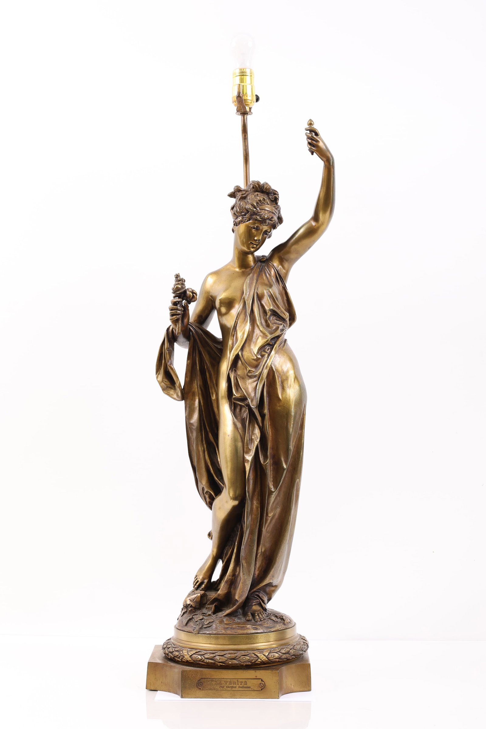 After Auguste Joseph Carrier (1800 - 1875): Gilt bronze sculpture, "La Verite (The Truth)", depicting a semi-nude woman in Neo-Classical style, impressed signature to the base, and mounted as a lamp. The object in the woman's left hand may be a