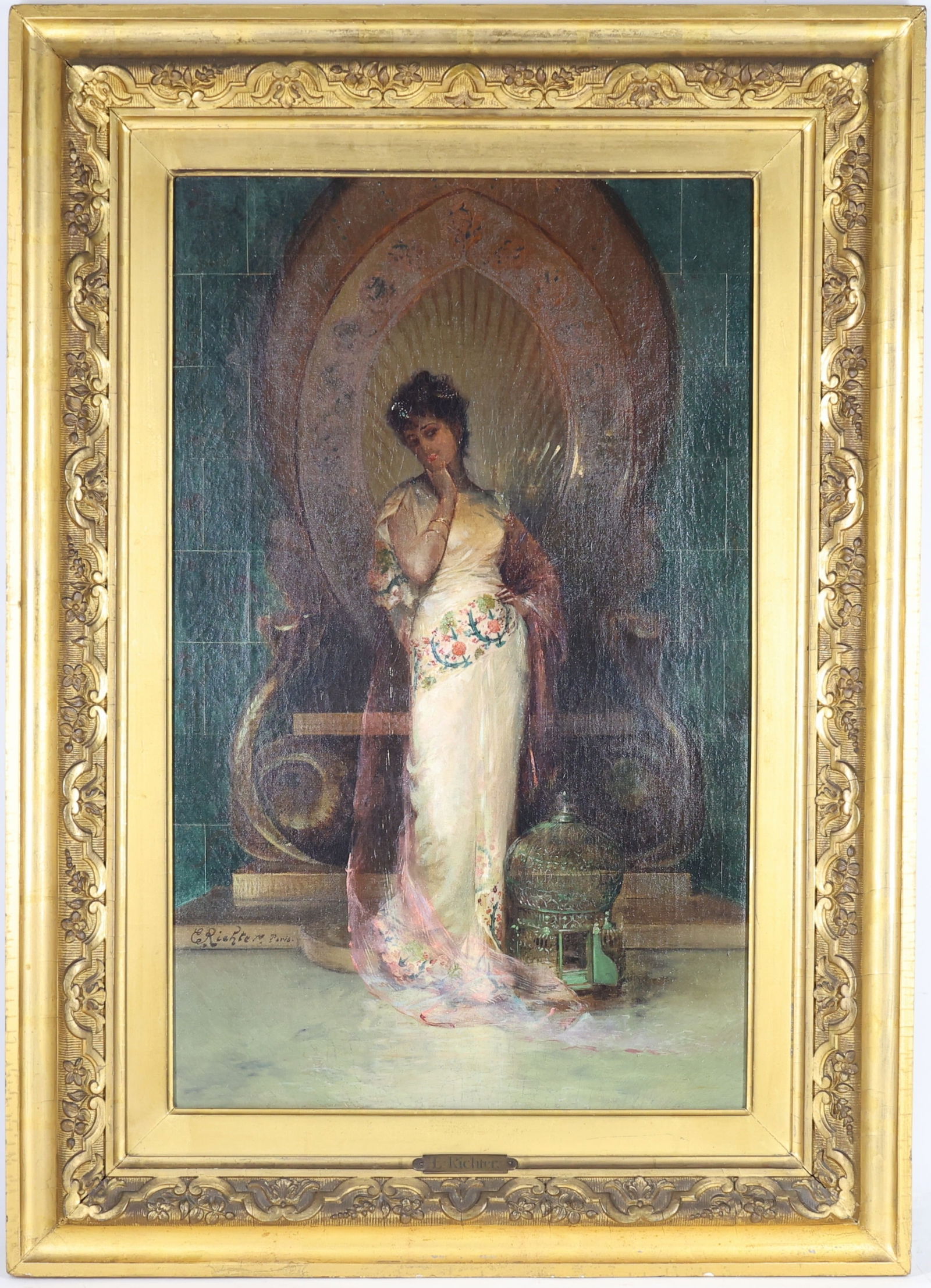 Edouard Frederic Wilhelm Richter (1844 - 1913): Oil on canvas, SLL. Orientalist portrait of a woman in an ivory gown standing before an ornate chair and green tiled wall, with a birdcage at her side. Relined. 24.25” x 15” and 32"h x 23"