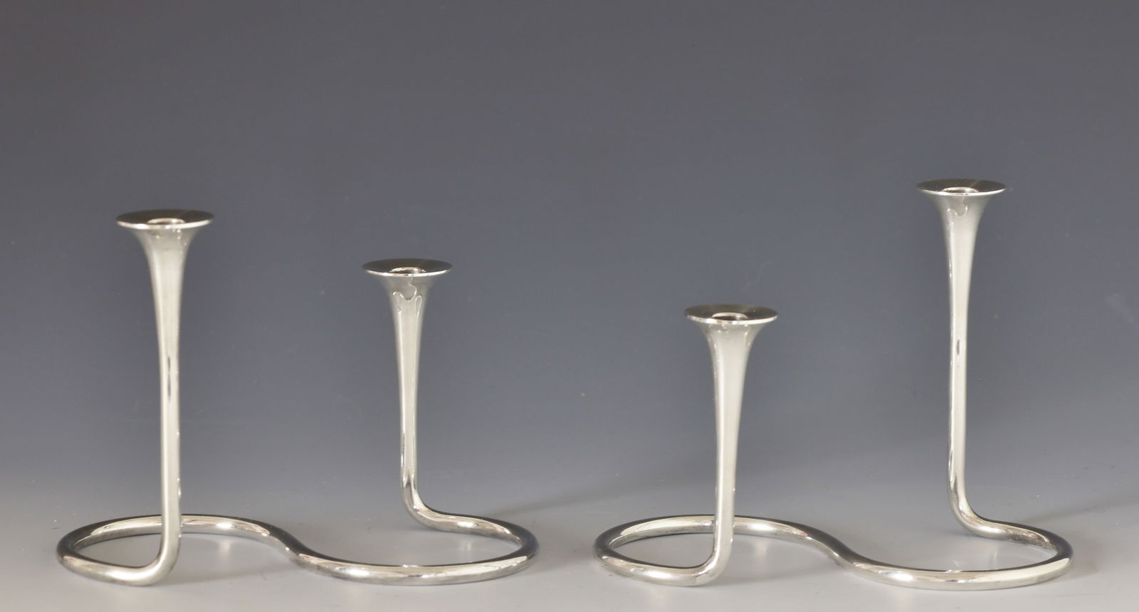 Anton Michelsen Sterling Silver Candlesticks: Danish Modern sterling silver pair of serpentine two-light candlesticks.75"h x 6"w x 4.5"d. 13.05 ozt