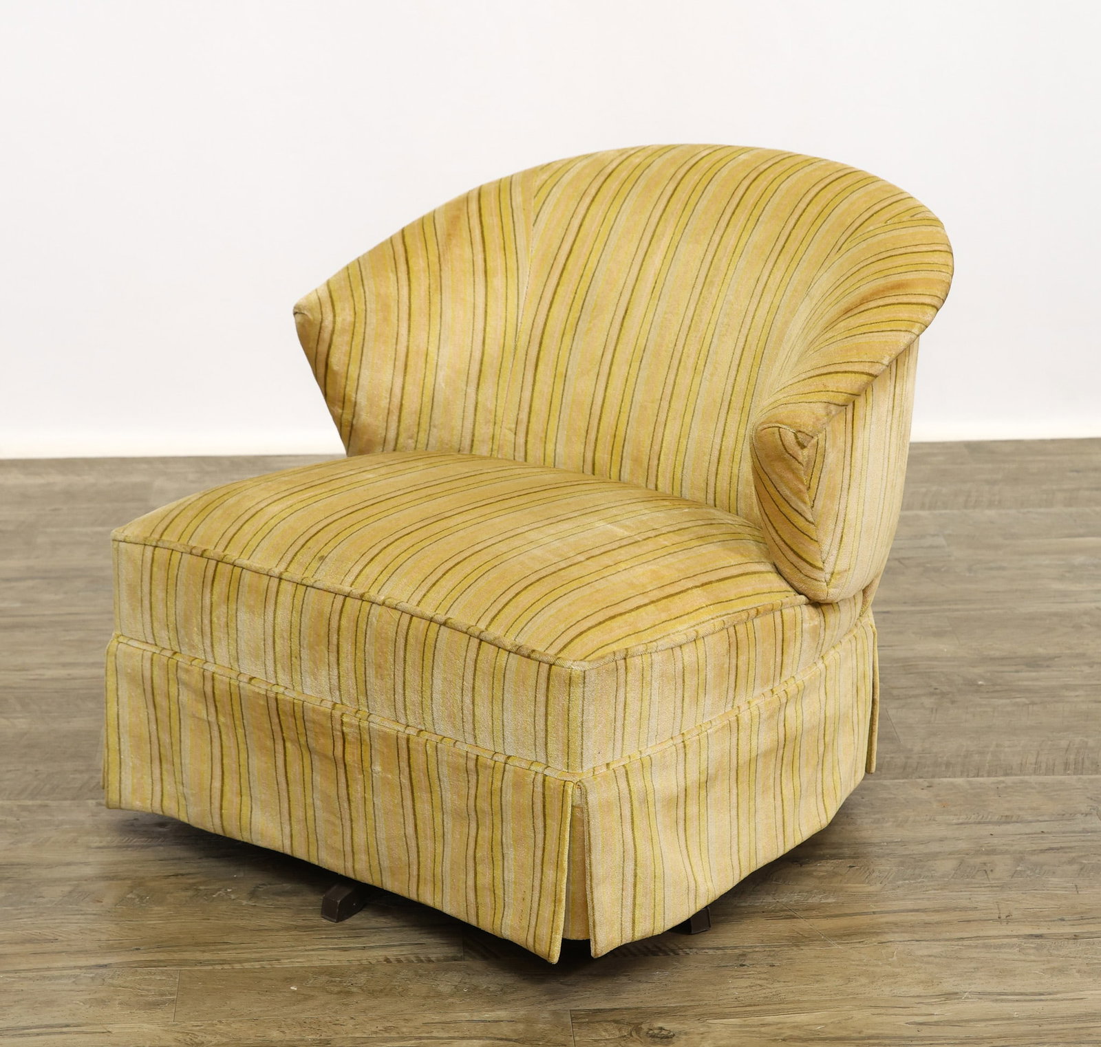 Swivel and Tilt Lounge Chair: Barrel back lounge chair with a steel five-star swivel and tilt base, fully upholstered in striped harvest gold. 27"h x 28"w x 30"d, seat height 15"