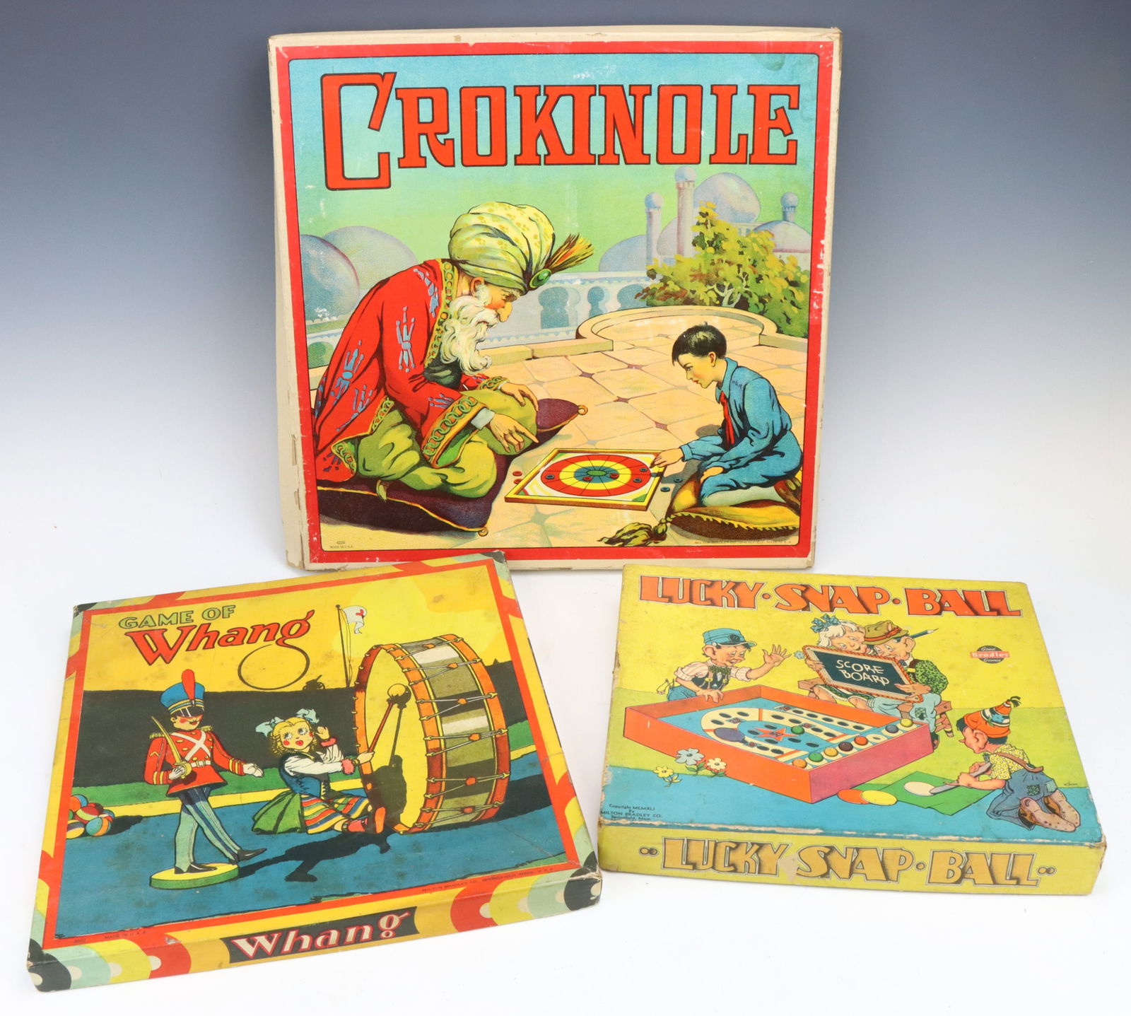 Vintage Board Games: Late 19th century game, Crokinole, a dexterity-based game, original box, 1”h x 15.25”w x 15.25”d. Milton Bradley Lucky, Snap, Ball game, original box and game accessories, not all pi