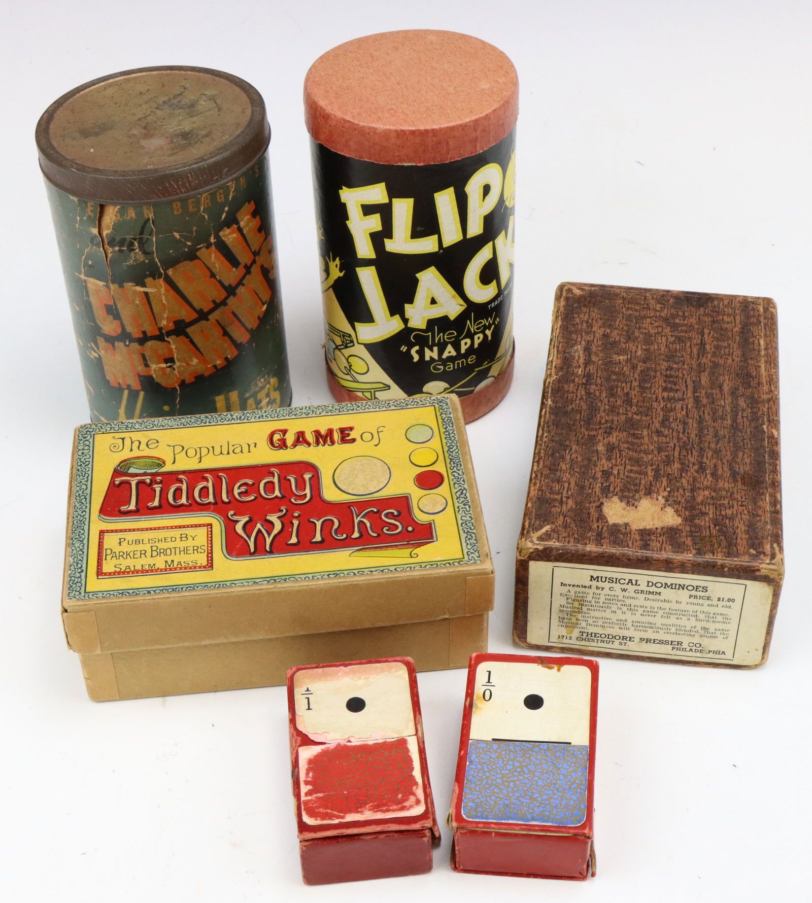 Assorted Vintage Games: Parker Brothers Game of Tiddledy Winks game, Russell Manufacturing Company Game of Flip Jack 1937, Charlie McCarthy's Flying Hats with original container, two sets of domino cards and Theodore Presser
