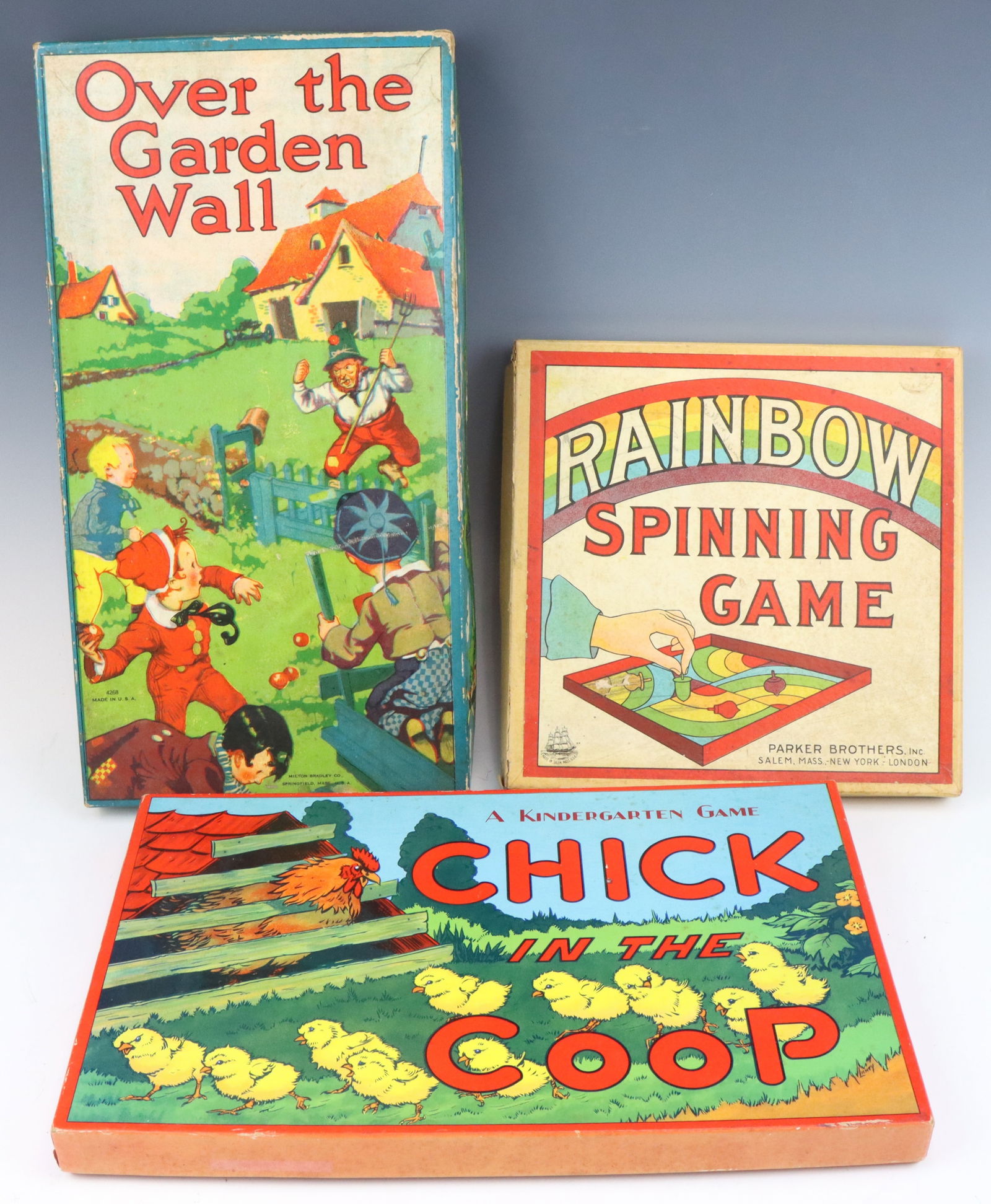 Vintage Games: Over the Garden Wall 1911 game by Milton Bradley, Chick in the Coop game circa 1940's by Saml Gabriel Sons & Co and Parker Brothers Rainbow Spinning game. All have original boxes with wear from age an