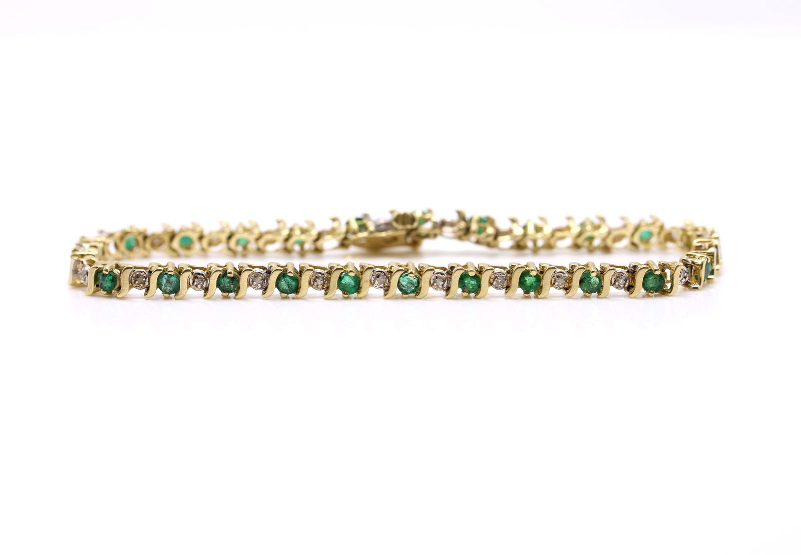 14k YG Emerald Diamond Bracelet: 14k yellow gold line bracelet set with 2.5mm round emeralds and diamond accents, 7" and 5.8dwt.