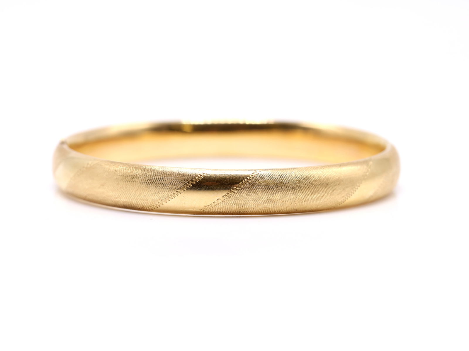 14k YG Bracelet: 14k yellow gold bangle bracelet with machined detailing, 7" and 7.3dwt.