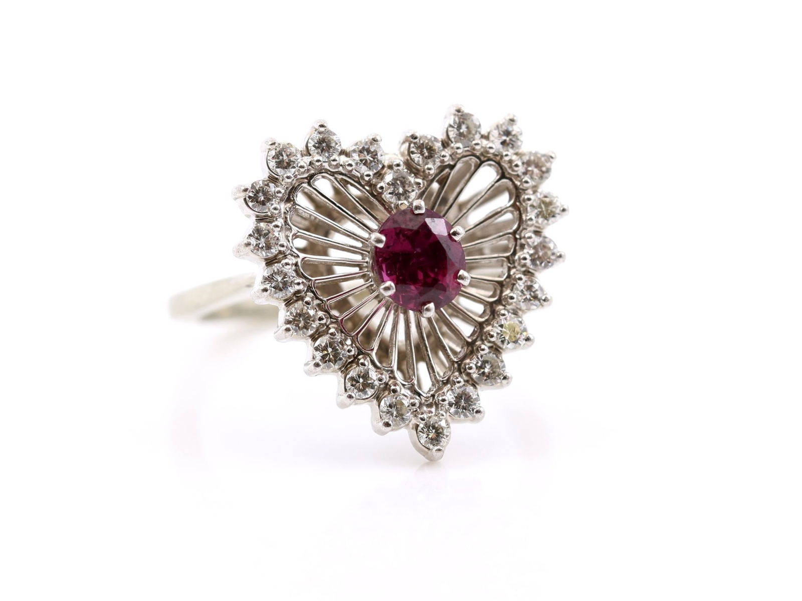 18k WG Ruby Diamond Ring: 18k white gold Jabel ring set with an oval ruby weighing approx. 0.5 carat, surrounded by a heart shaped halo of round brilliant cut diamonds. Size 5 and 3.2dwt.