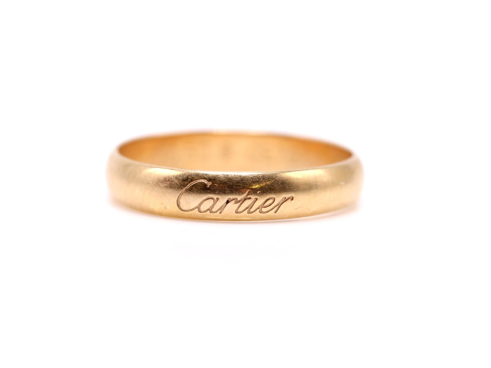 18k YG Cartier RIng: Cartier 18k yellow gold wedding band, engraved signature, size 5.5 and 1.5dwt.