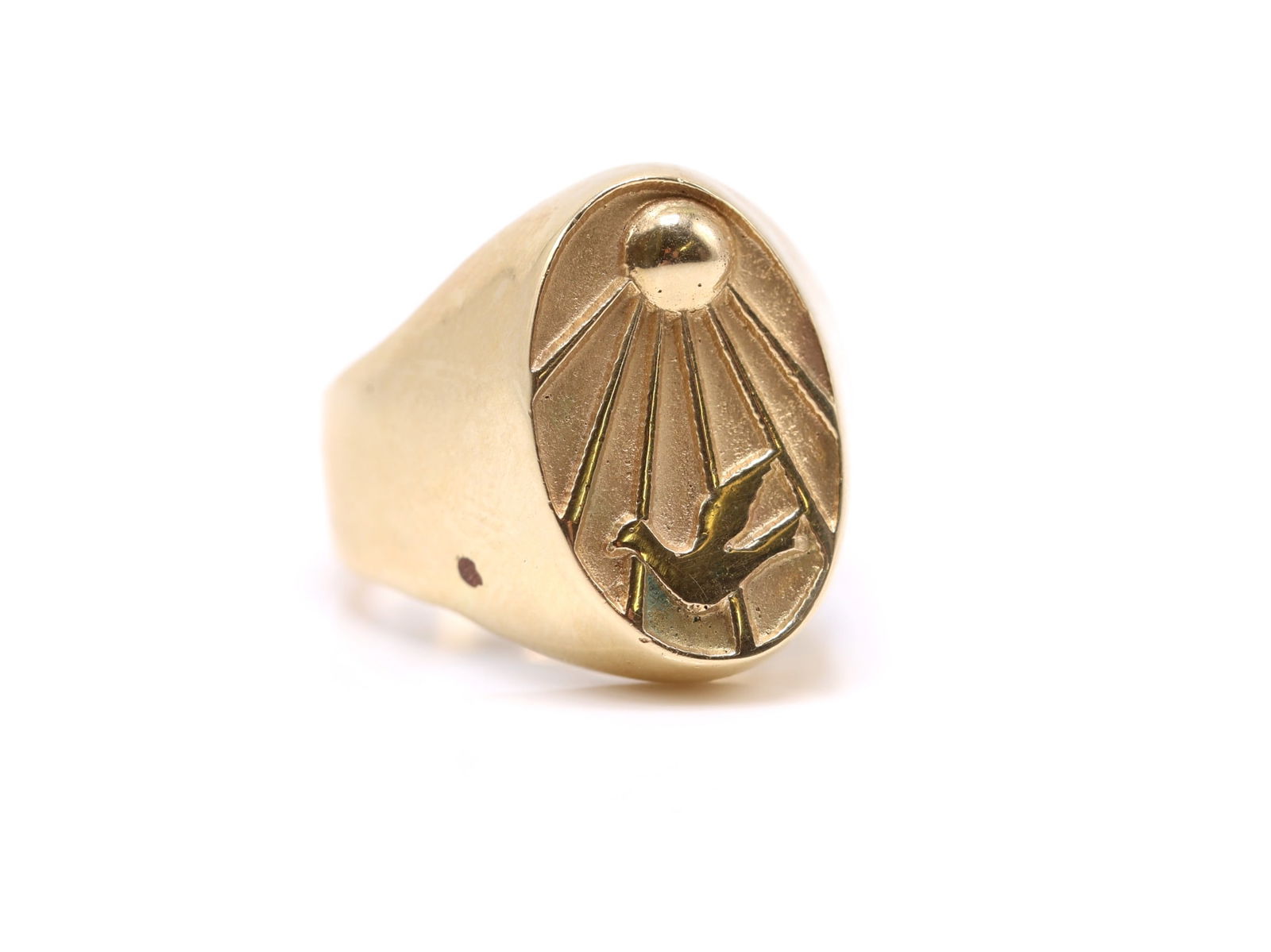 14k YG Ring: 14k yellow gold signet ring with oval bezel engraved with a stylized dove and radiating sunburst. Size 7.25 and 8.5dwt.