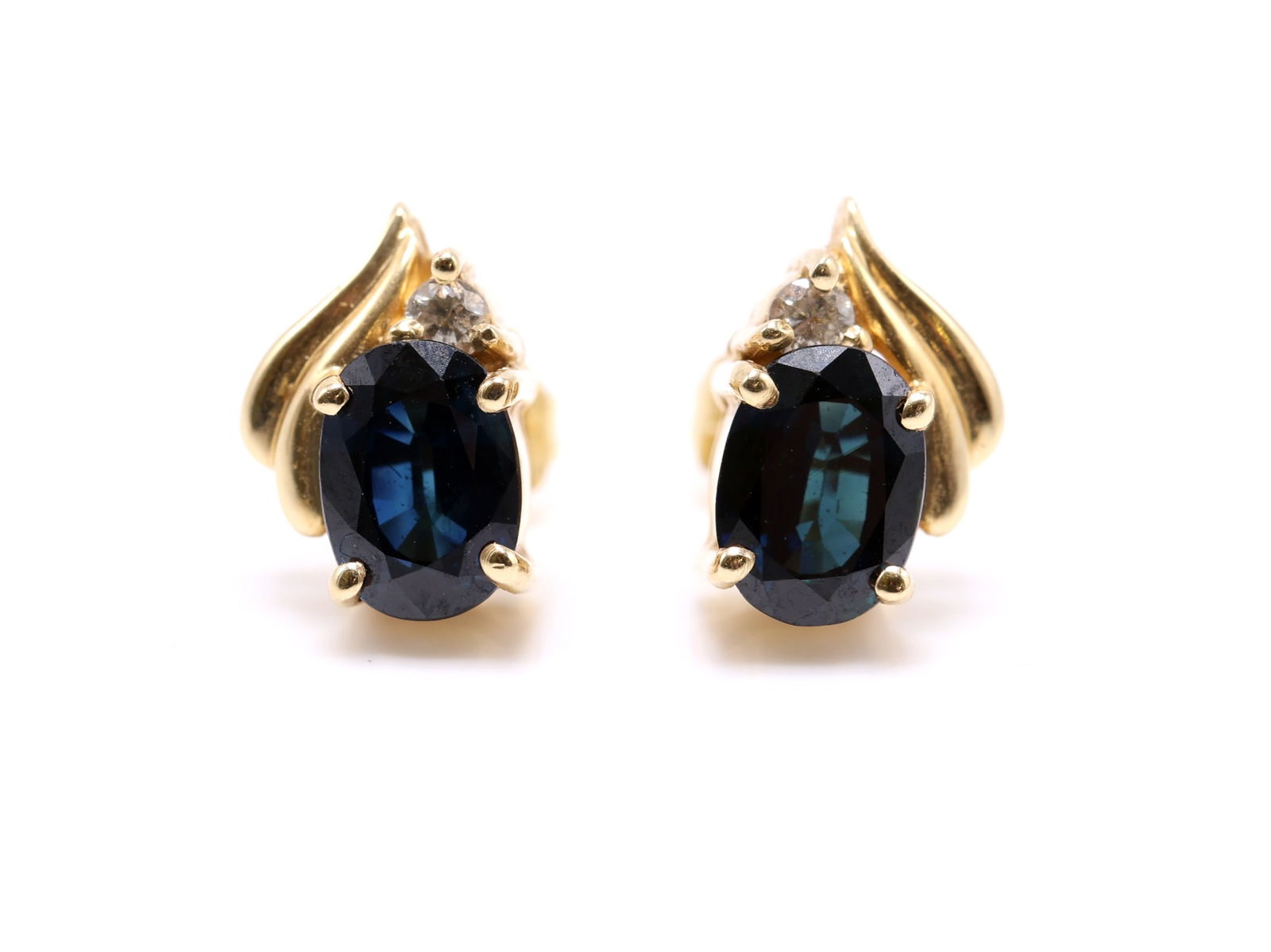 14k YG Topaz Earrings: 14k yellow gold earrings set with oval cut blue topaz accented by small round diamonds, measuring approx. 0.5" and 1.8dwt.