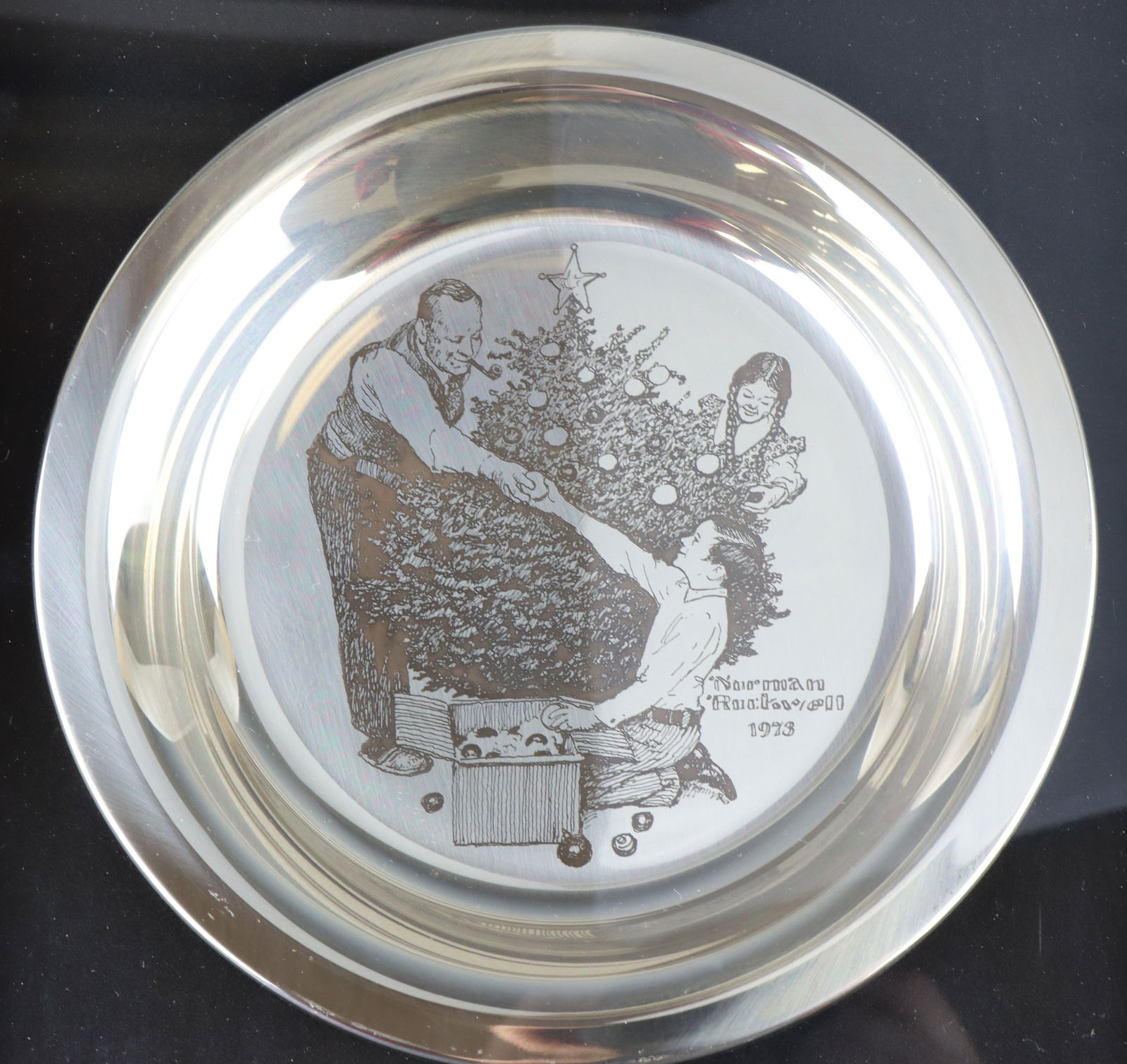 Franklin Mint Sterling Silver Norman Rockwell Christmas Plate: Trimming the Tree sterling silver Christmas Plate 1973, mounted in a shadow box frame. Includes paperwork. 8", and 5.7 ozt