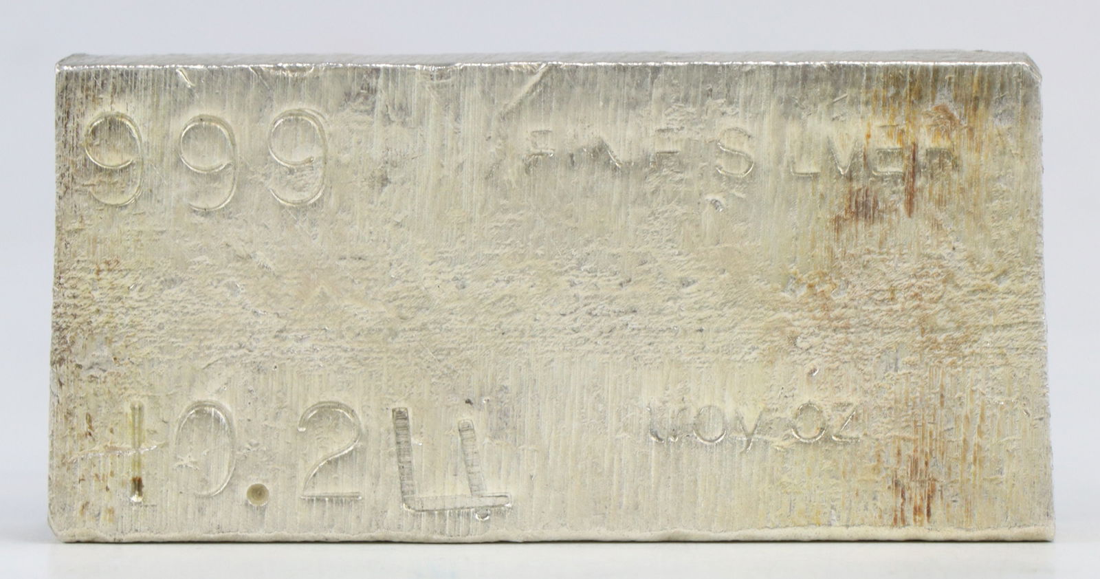 10 Ozt Fine Silver Bar: Poured 999 fine silver bar, stamp marked with purity and weight. 2.75" x 1.25" x 0.5" thick. 10.24 ozt