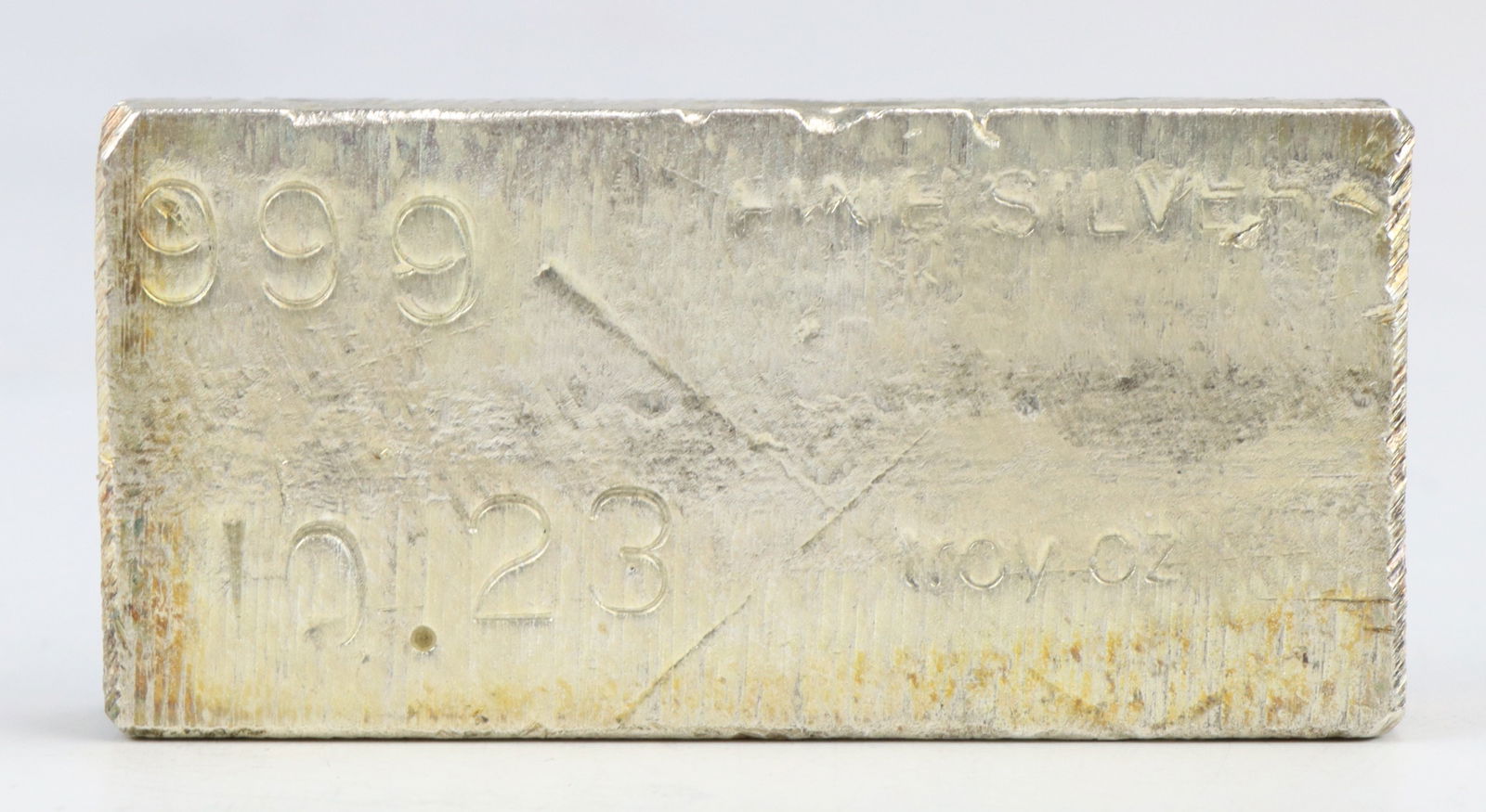 10 Ozt. Fine Silver Bar: Poured 999 fine silver bar, stamp marked with purity and weight. 2.75" x 1.25" x 0.5" thick. 10.21 ozt