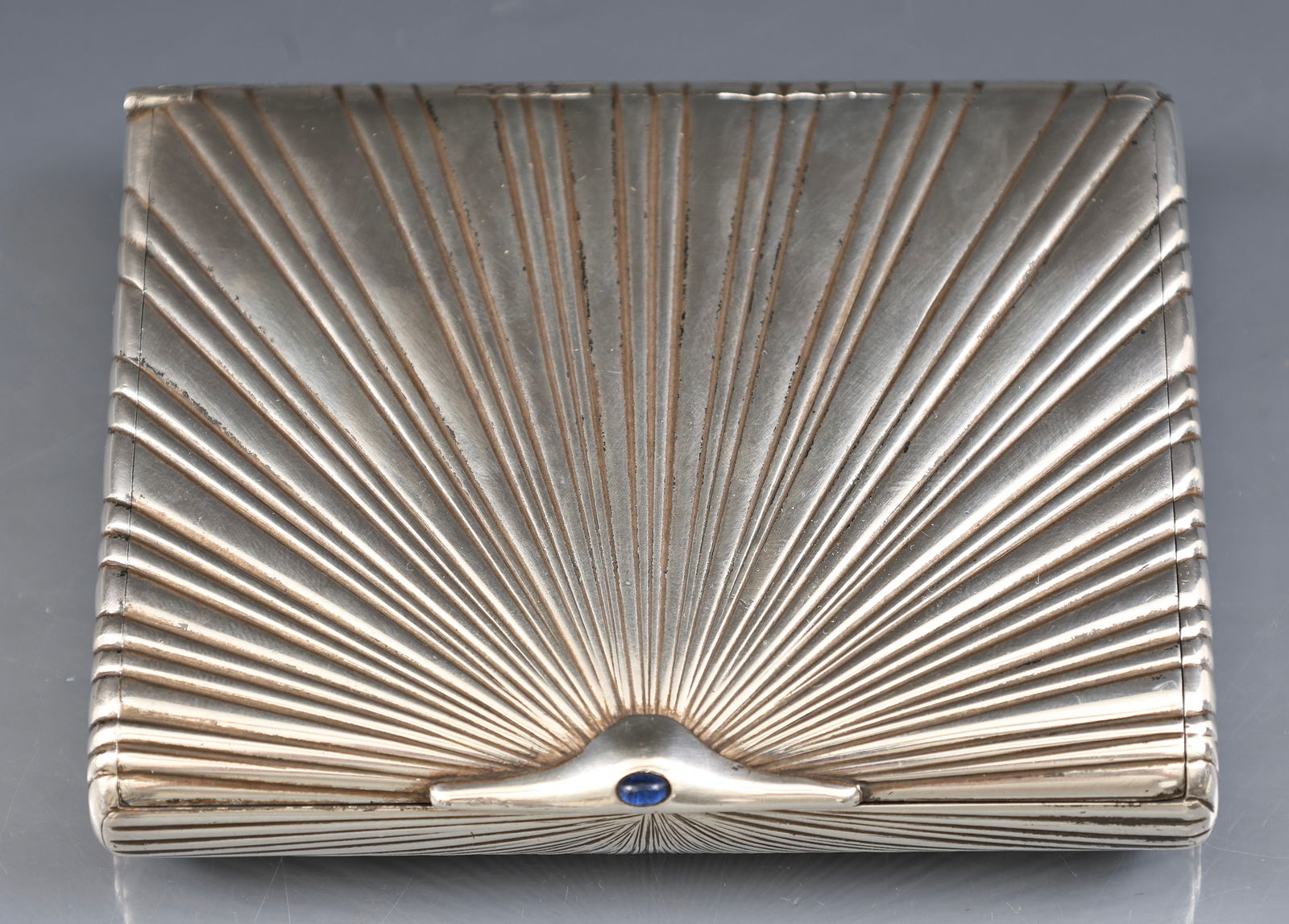Imperial Russian Silver Cigarette Case: 84 zolotnik (875 silver) Art Deco cigarette case with fluting and a blue cabochon at the latch, marked to the interior with the 1908 - 1926 kokoshnik for St. Petersburg, maker "AO" (Cyrillic), and wit