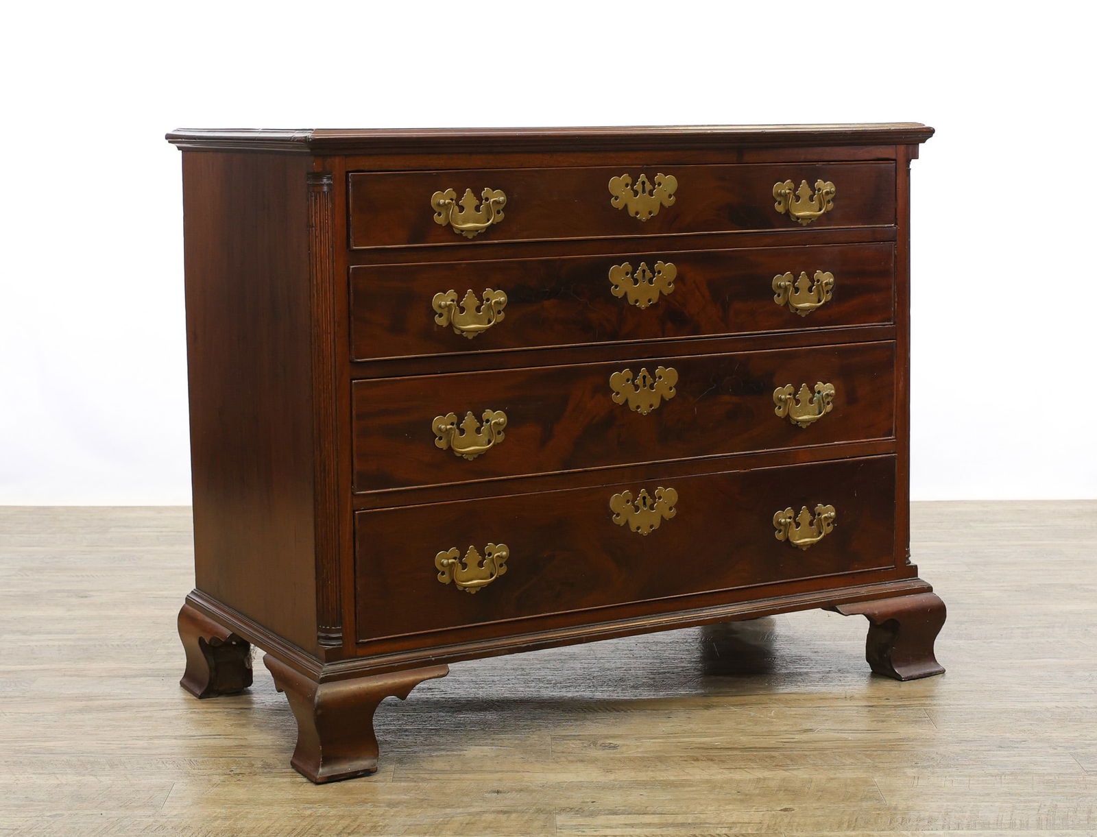 Philadelphia Chippendale Mahogany Chest of Drawers: Chamfered top having four graduated dovetail drawers with batwing pulls flanked by reeded quarter columns on ogee bracket feet. 34"h x 40.5"w x 21.5"d