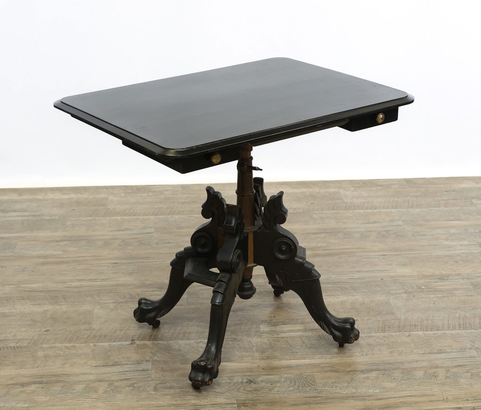 Gates Mfg Co. Rotary, Adjustable, Sliding Top Folding Table: Ebonized chamfered rectangular top, turned brass pedestal and fixtures, on scrolled winged legs and hairy paw feet. Gates Mfg Co., Philadelphia, PA, circa 1880. 32.5"h (43" tilt) x 32"w x 24'd