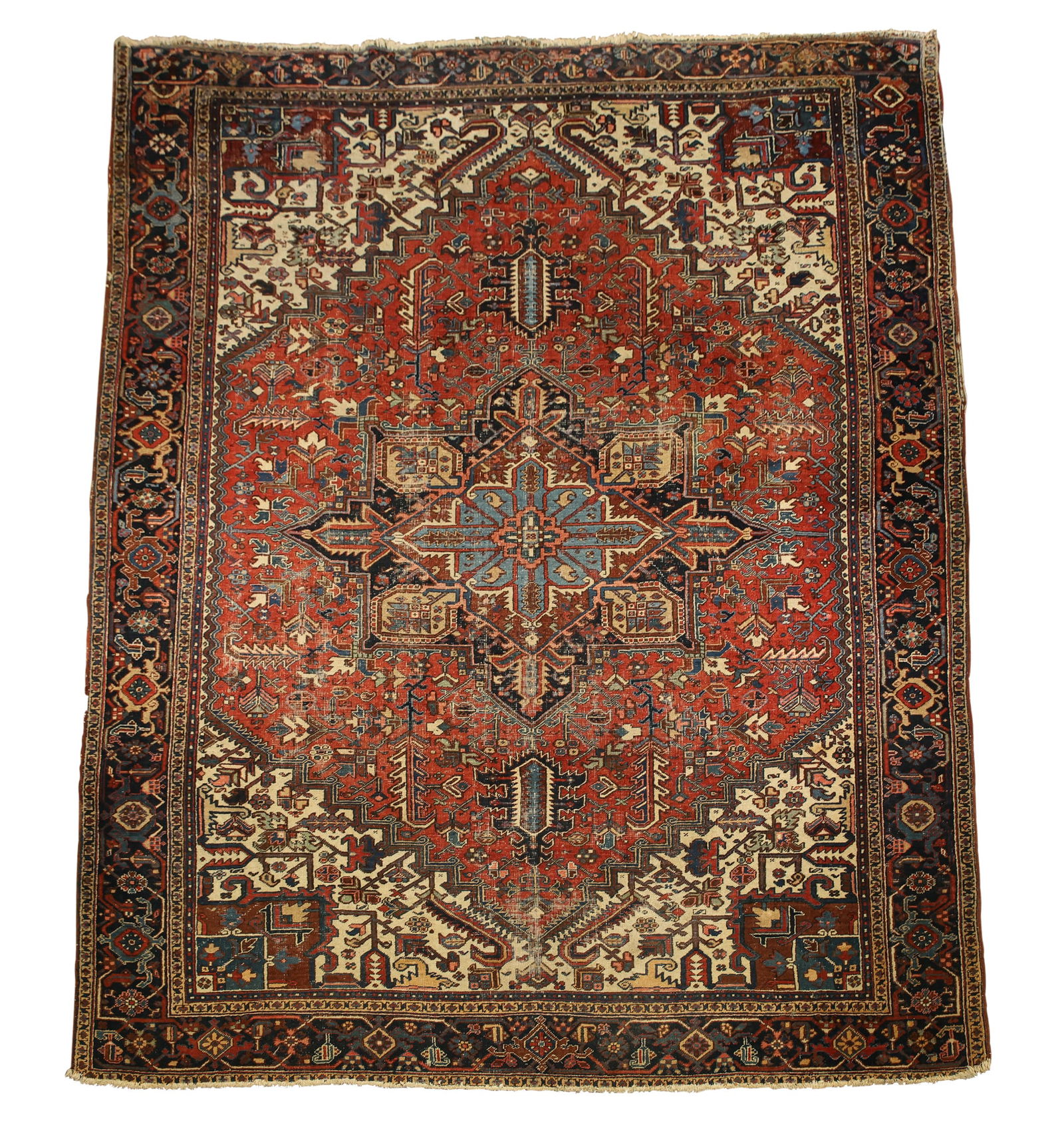 Persian Heriz Rug: Hand knotted having a double diamond and rectilinear four cornered central medallion with pendants, foliate leaf motifs in the main field and spandrels with a meandering diamond flowerhead and