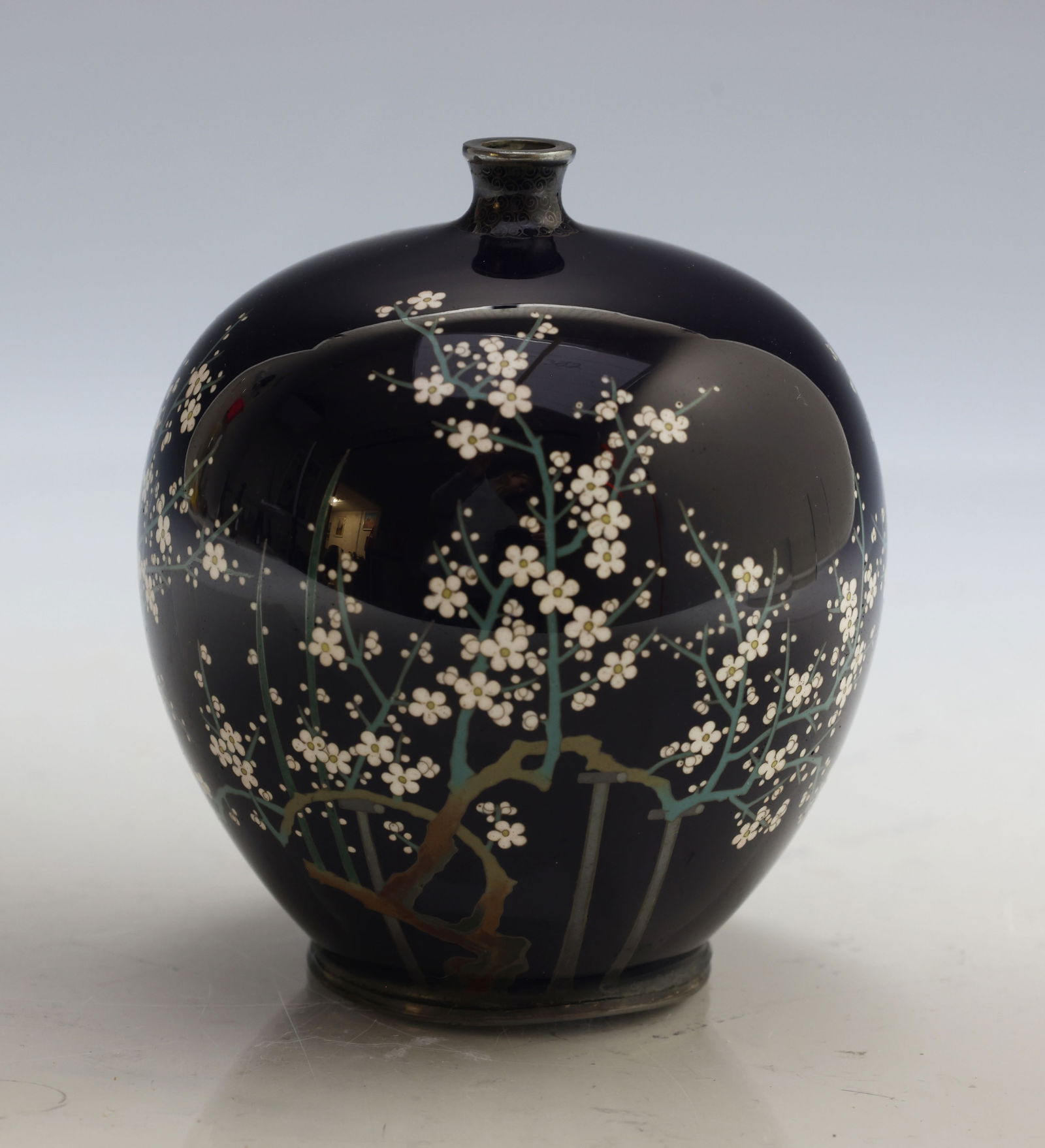 Hayashi Hachizaemon Japanese Cloisonne Vase: Meiji era silver wire cloisonne bulbous bud vase decorated with cherry blossoms on a black ground. Marked to the foot. 3.25"h x 2.75"w