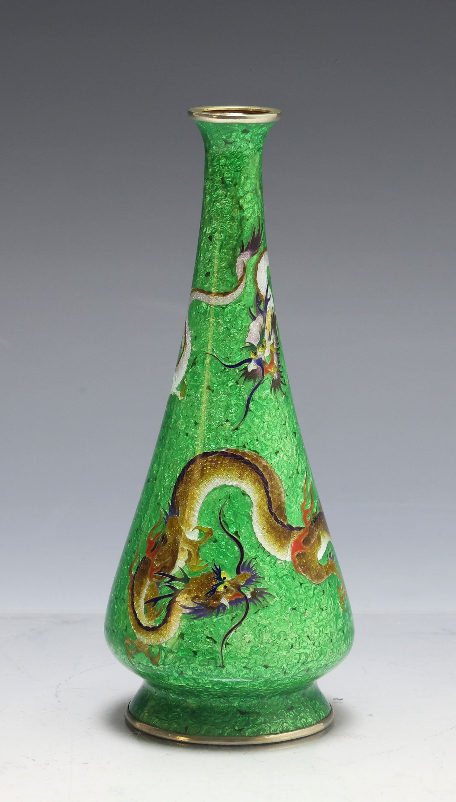 Japanese Ginbari Cloisonne Vase: Meiji - Taisho era ginbari and silver wire cloisonne vase depicting two dragons in flight on a green ground. Marked to the foot by an unidentified maker. 6"h x 2.25"w