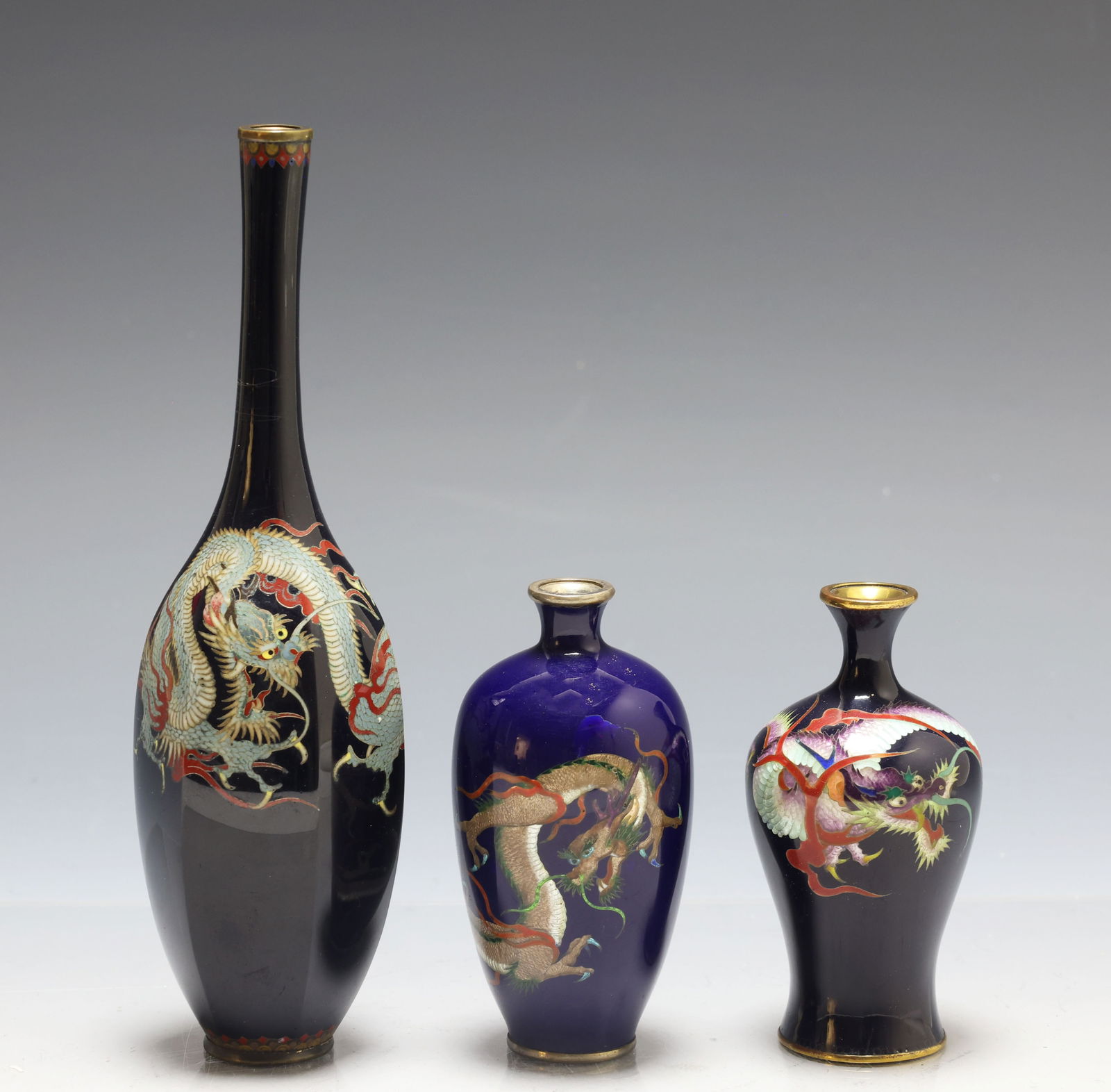 Japanese Cloisonne and Ginbari Vases: Meiji - Taisho era silver wire cloisonne vases of various forms, all decorated with dragons in flight on black or midnight blue grounds, the smaller vases with ginbari dragons. All unmarked. The blue