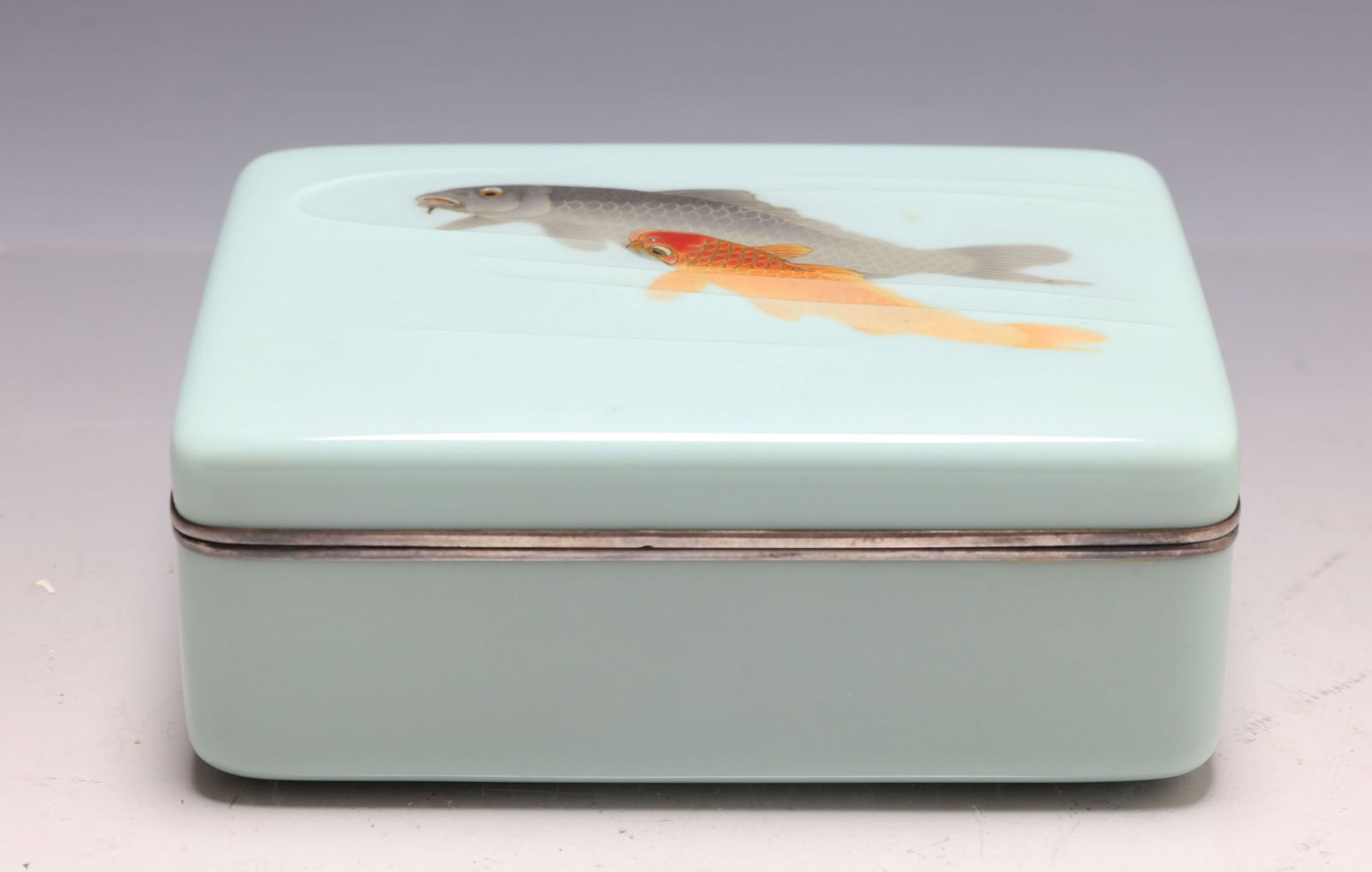 Japanese Moriage Cloisonne Box: Meiji - Taisho era silver wire and musen (wireless) cloisonne box with textured moriage decoration depicting a common carp and a golden carp on a blue-green ground, with silver mounts, and a silk line