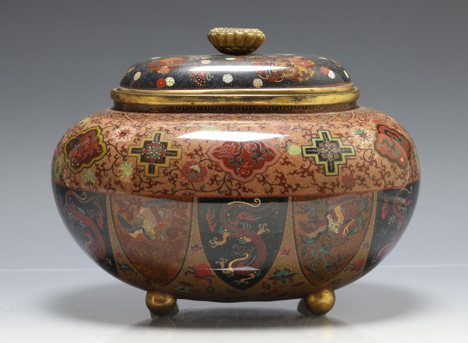 Japanese Goldstone Cloisonne Censer: Meiji - Taisho era silver wire cloisonne oval koro censer with a lotus form finial and raised on ball feet, the lower half of the body decorated with goldstone lappets featuring dragons and phoenixes