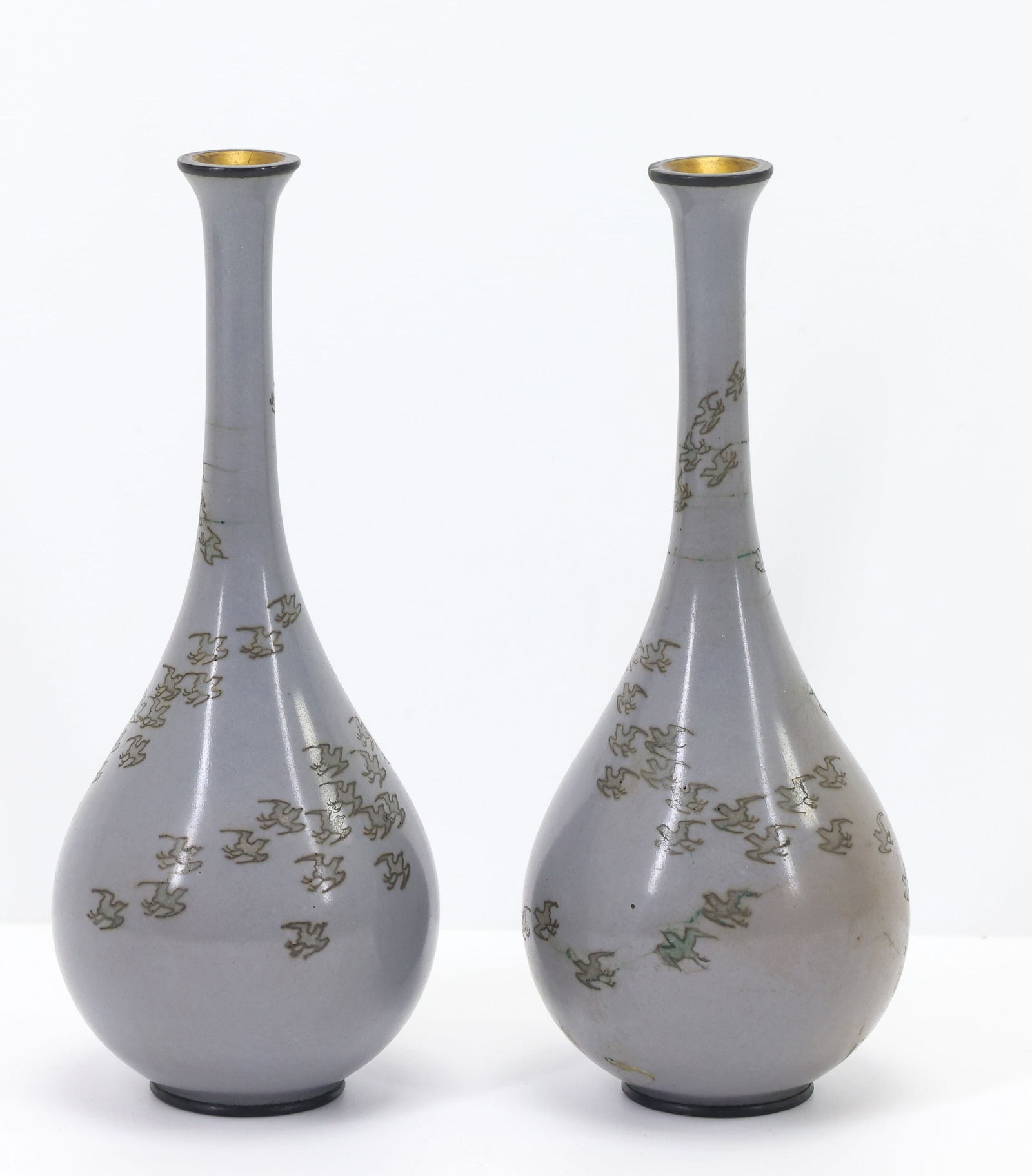Namikawa Yasuyuki Japanese Cloisonne Vases: Meiji - Taisho era pair of small silver wire cloisonne bottle vases decorated with birds flying in formation on a steel blue ground. Engraved marks for Namikawa Yasuyuki (1845 - 1927) on silver tablet