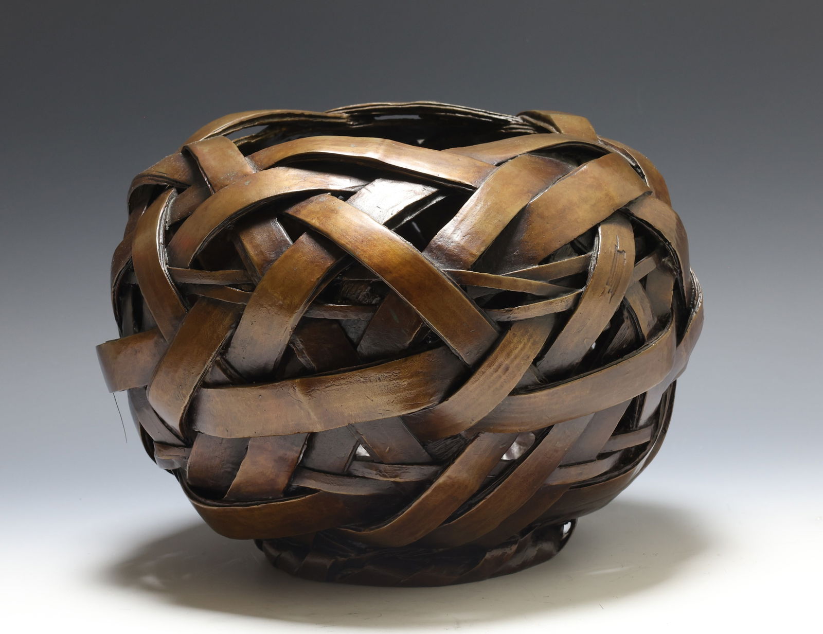 Japanese Bronze Ikebana Vessel: Meiji - Taisho era bronze flower holder in the form of a bamboo basket. Unmarked. 8.5"h x 11"w