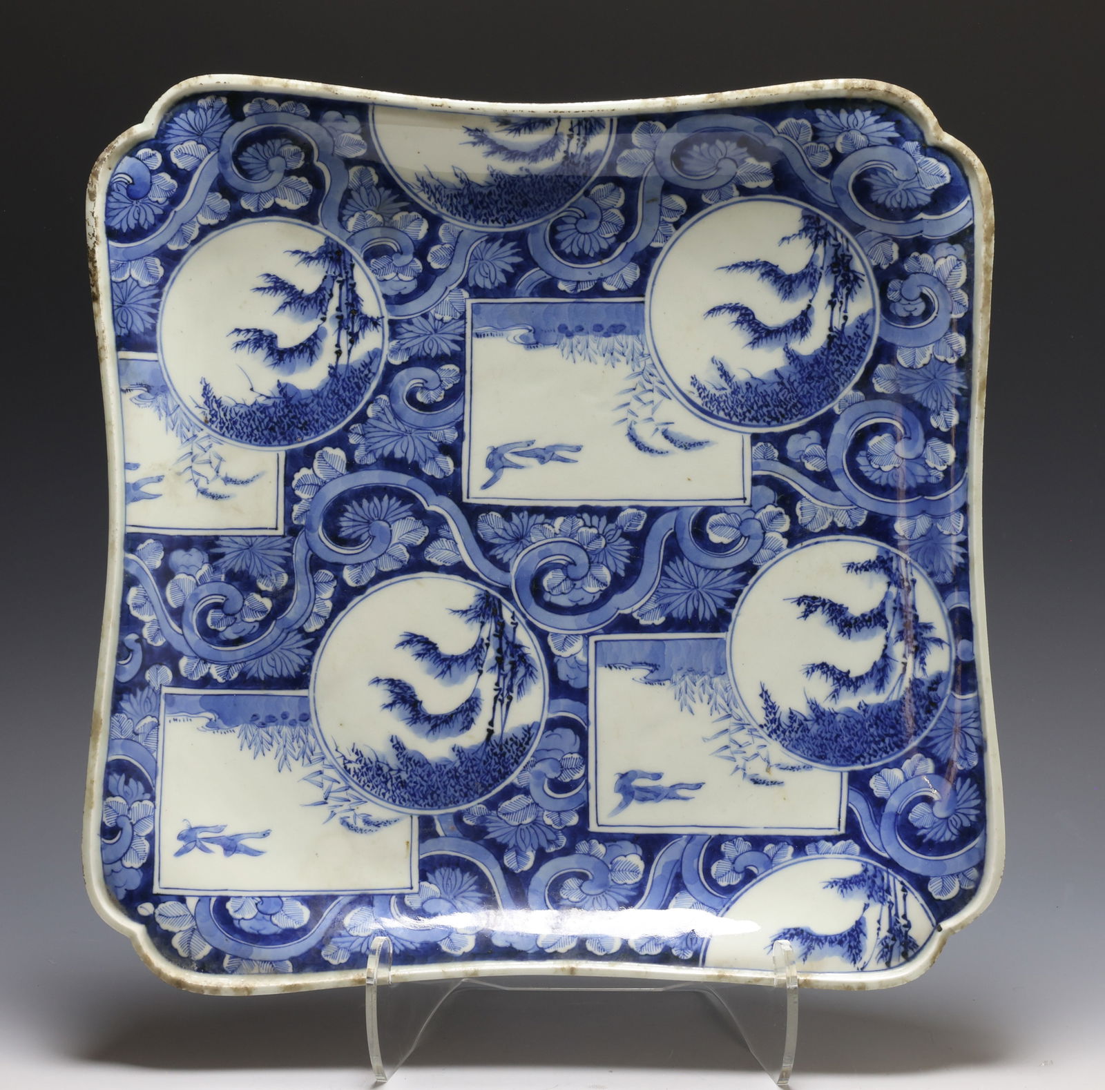 Japanese Imari Porcelain Platter: Circa Meiji era blue and white porcelain scalloped square platter, decorated with panels depicting birds and foliage on a scrolling floral background. Spurious Chenghua reign mark to the foot. 2"h x 1